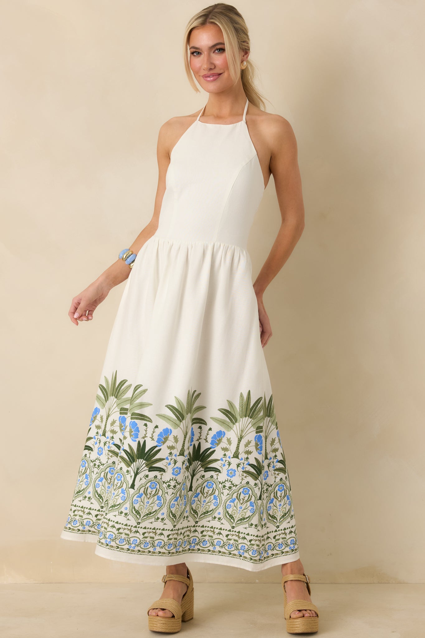 Ivory midi dress with fitted bodice, gathered skirt, and airy drape to mid-calf.