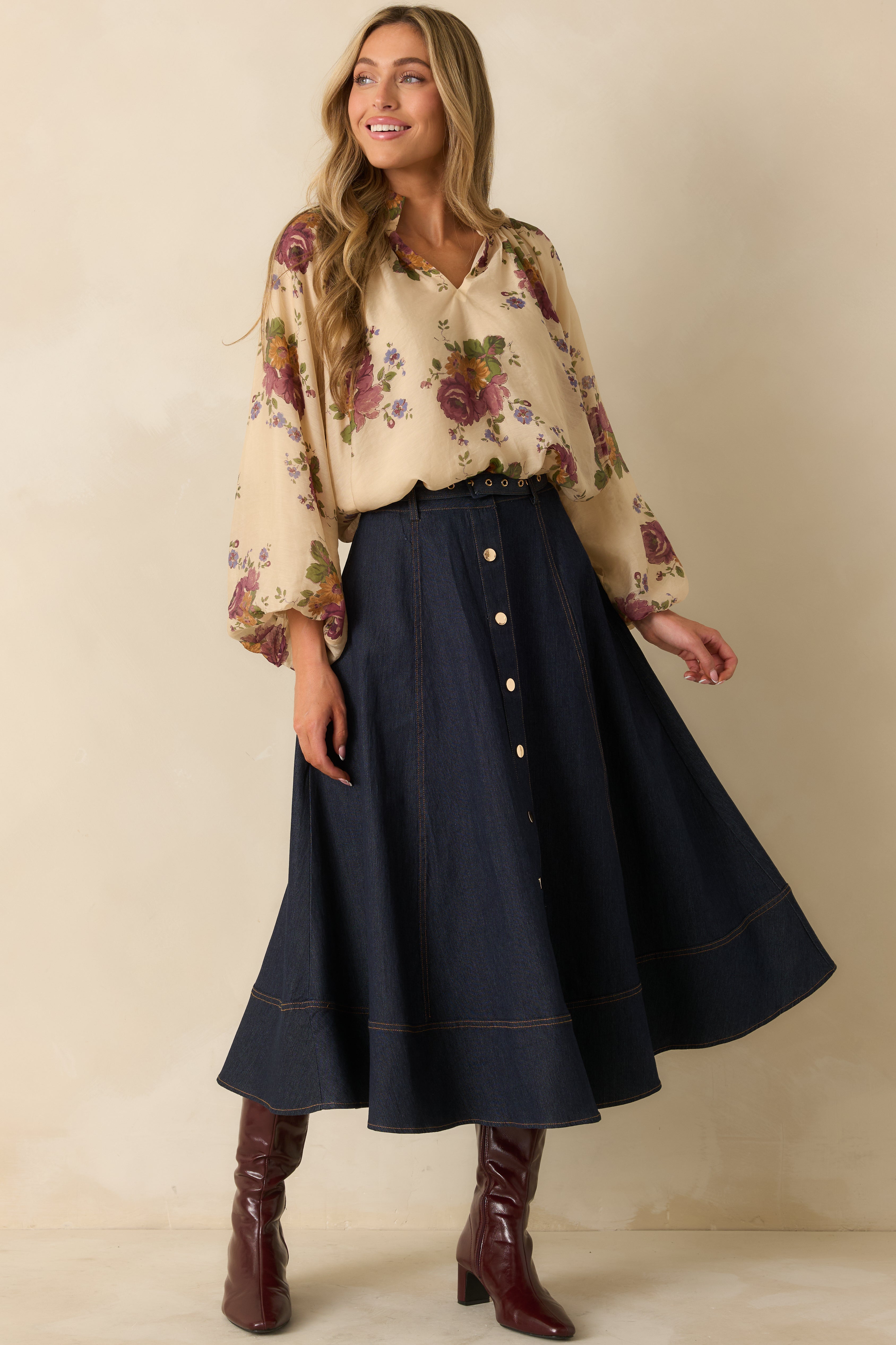 Ivory blouse with a multi floral print, split neckline, and relaxed fit.