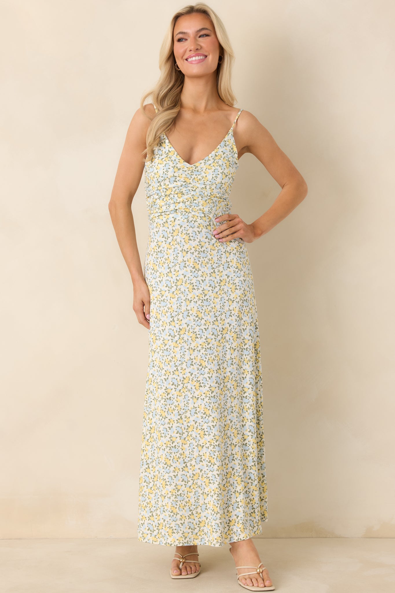 Ivory multi maxi dress with adjustable spaghetti straps, ruched bodice, and a relaxed A-line skirt in a ditsy floral print.
