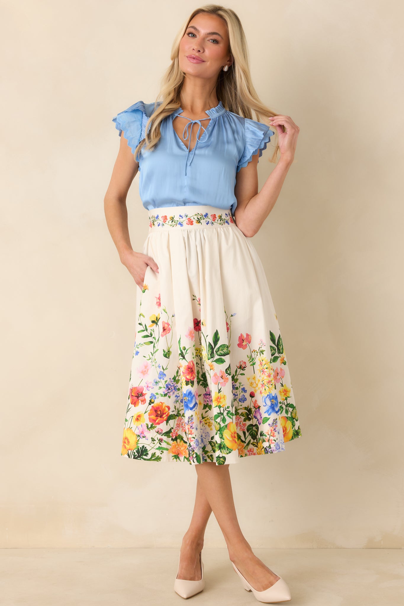 Ivory multicolor floral midi skirt with an A-line silhouette, soft structure, and smooth cotton satin fabric.