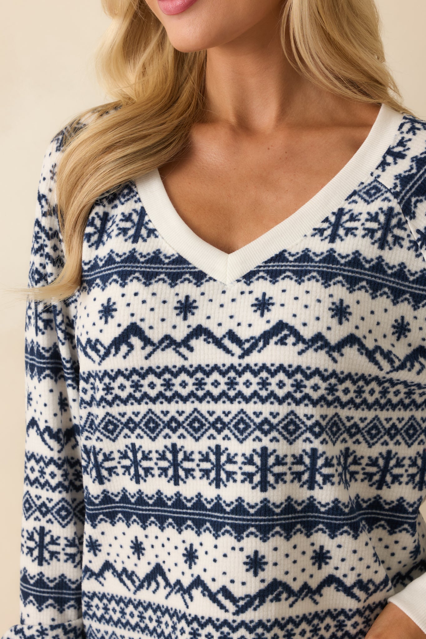 Close-up of the velvety waffle texture and intricate ivory and navy Fair Isle knit pattern.