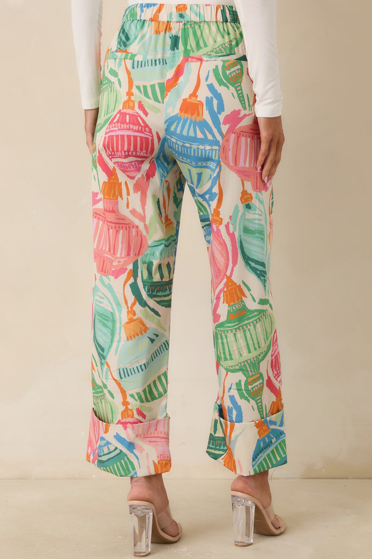 Rear of the ivory ornament-print pants featuring an elasticized back waistband and wide legs.