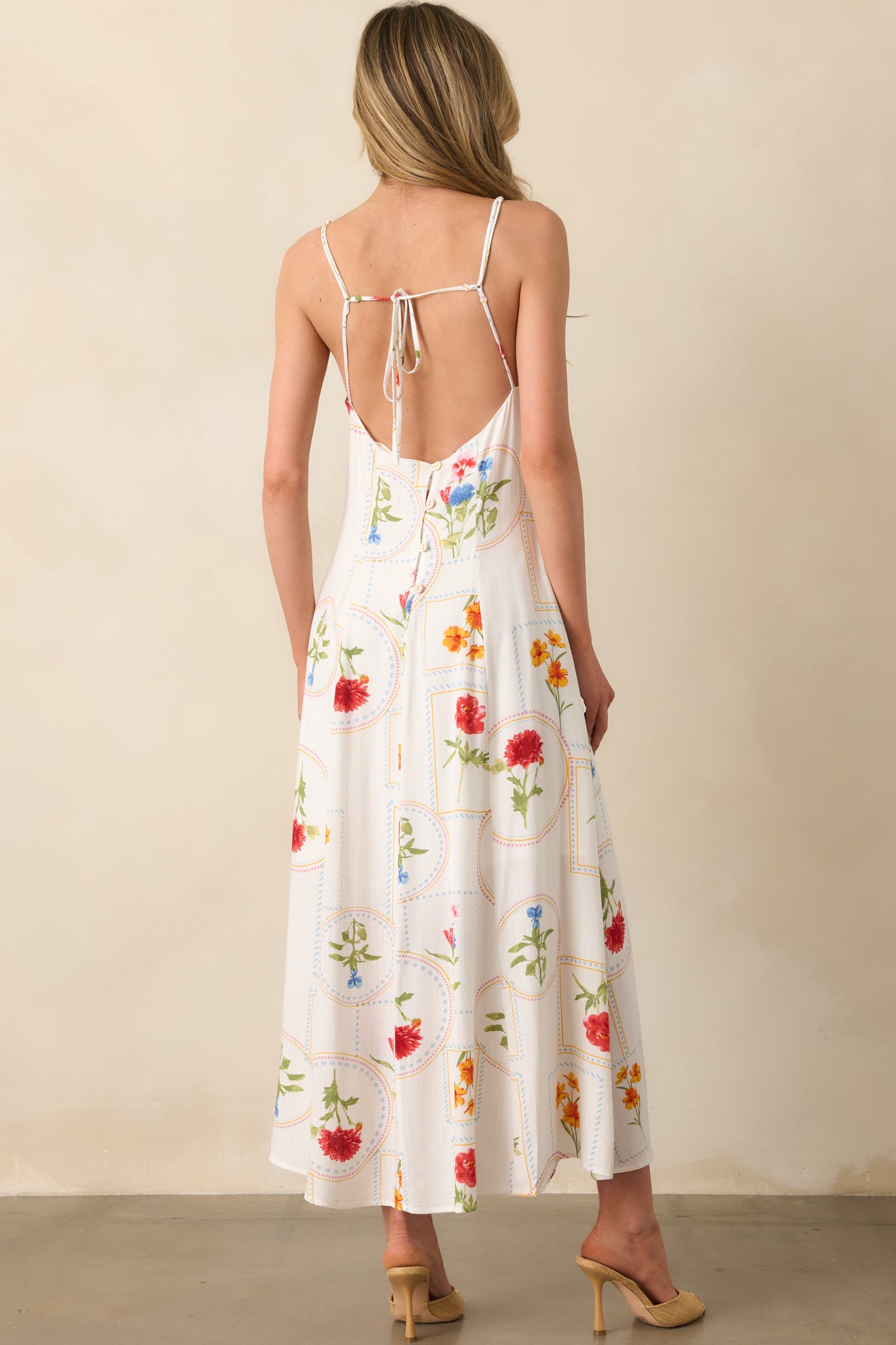 A back view showing the open-back design, self-tie back closure, and adjustable straps of the ivory patchwork dress.