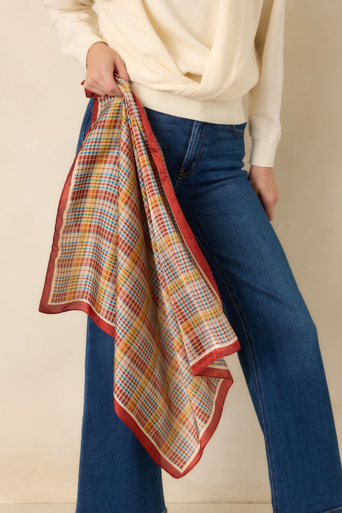 Ivory plaid scarf features intersecting rust, golden yellow, and blue lines framed by a solid rust border and narrow ivory inset.