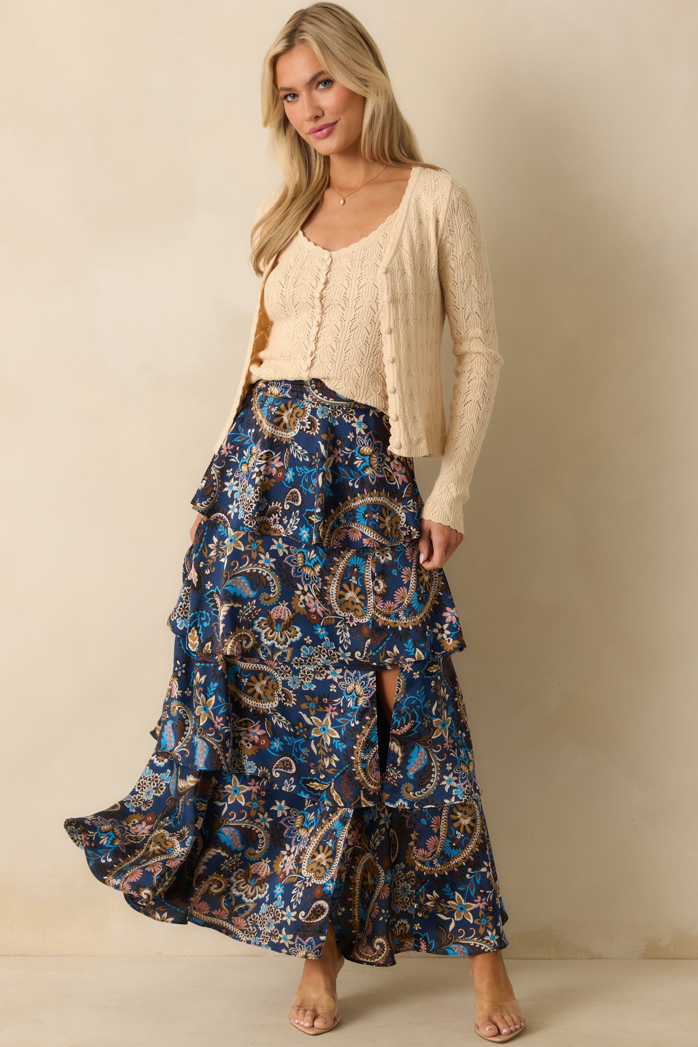 Ivory pointelle knit cardigan with scallop v-neckline and cropped length.