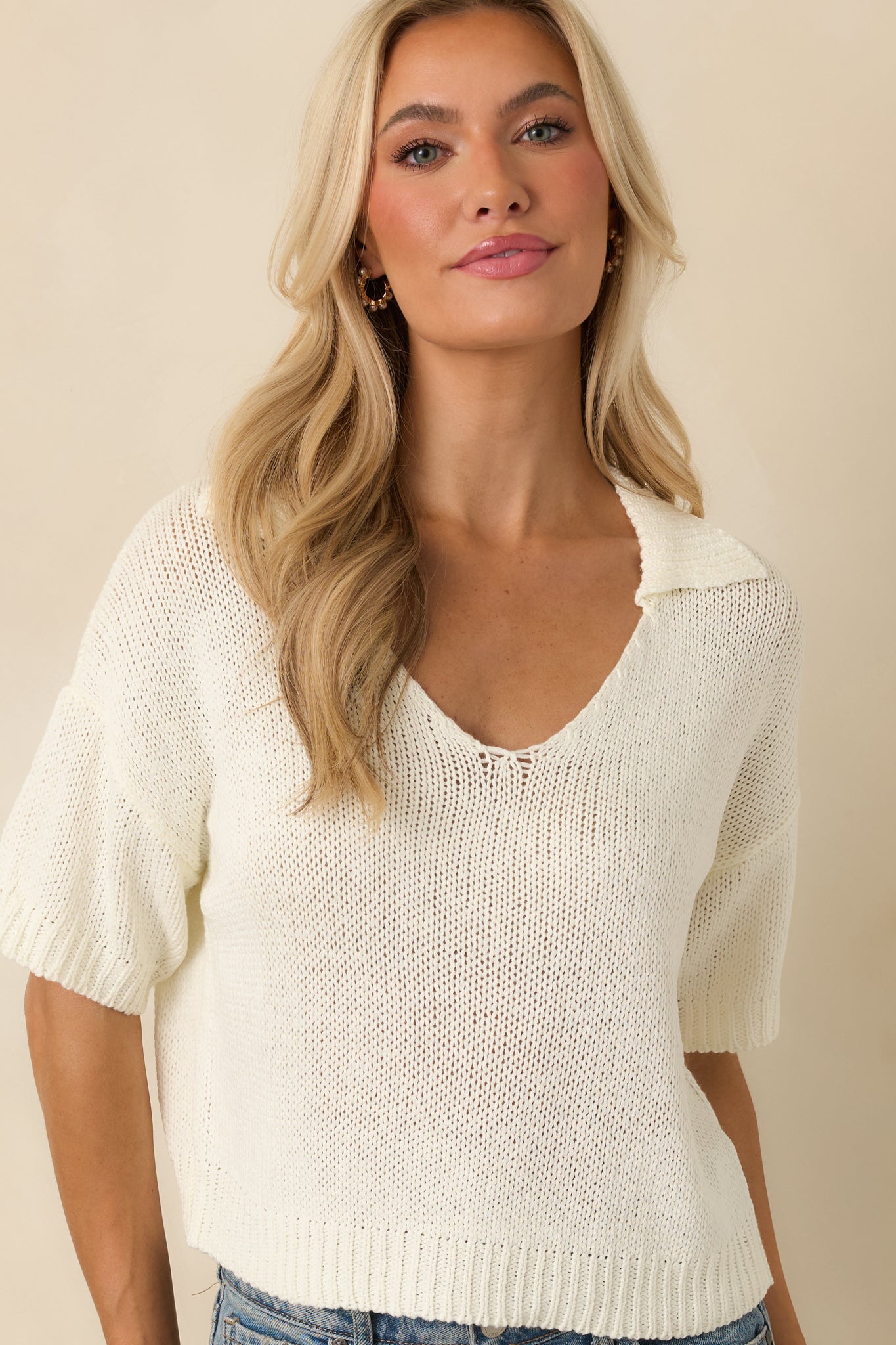 Front-facing ivory pullover featuring a lightweight open-knit design, relaxed fit, and polished collar detail.