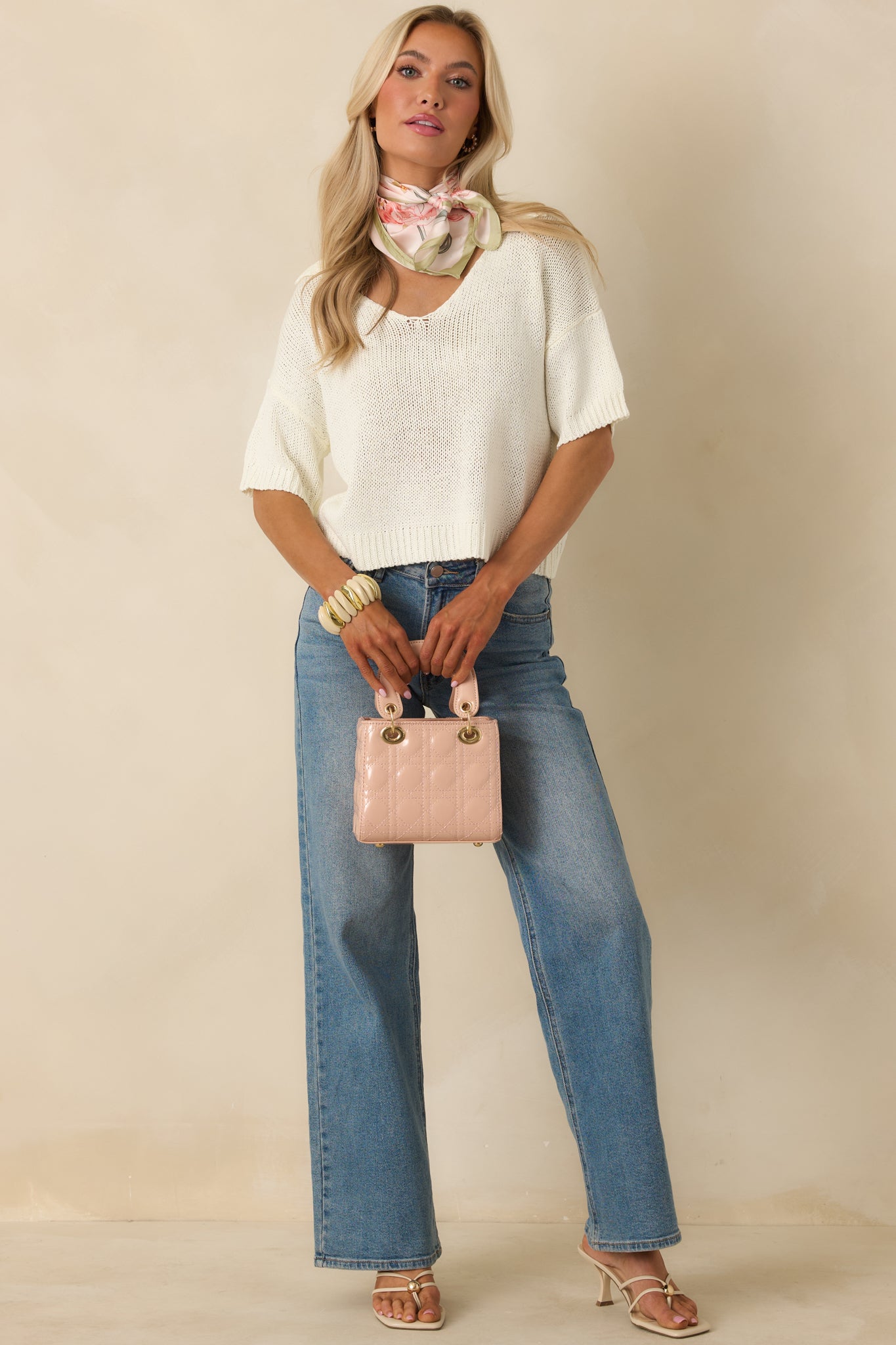 Lightweight ivory pullover featuring a breathable open-knit texture, easy pull-on design, and a softly draped relaxed fit.