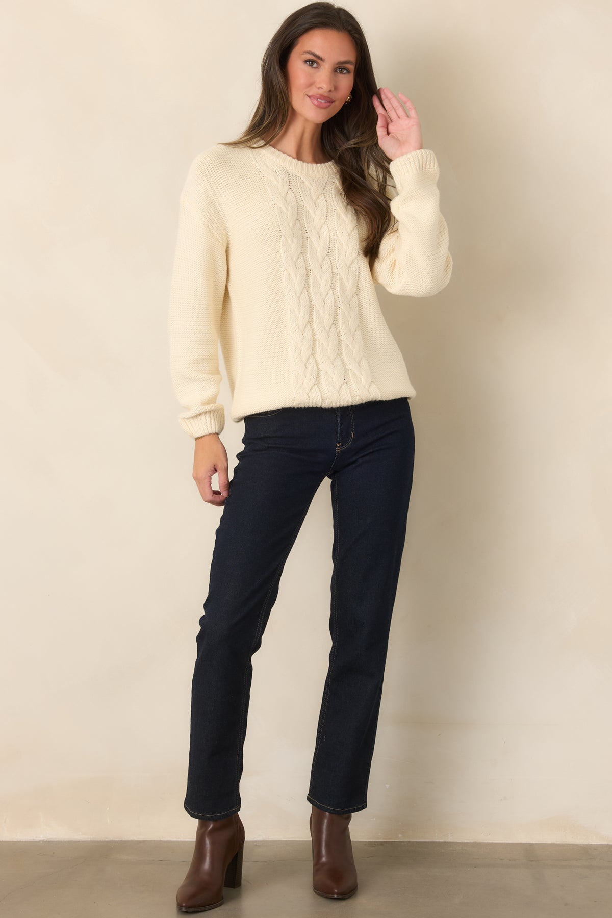 Relaxed ivory pullover sweater featuring soft knit fabric and a textured cable knit front.