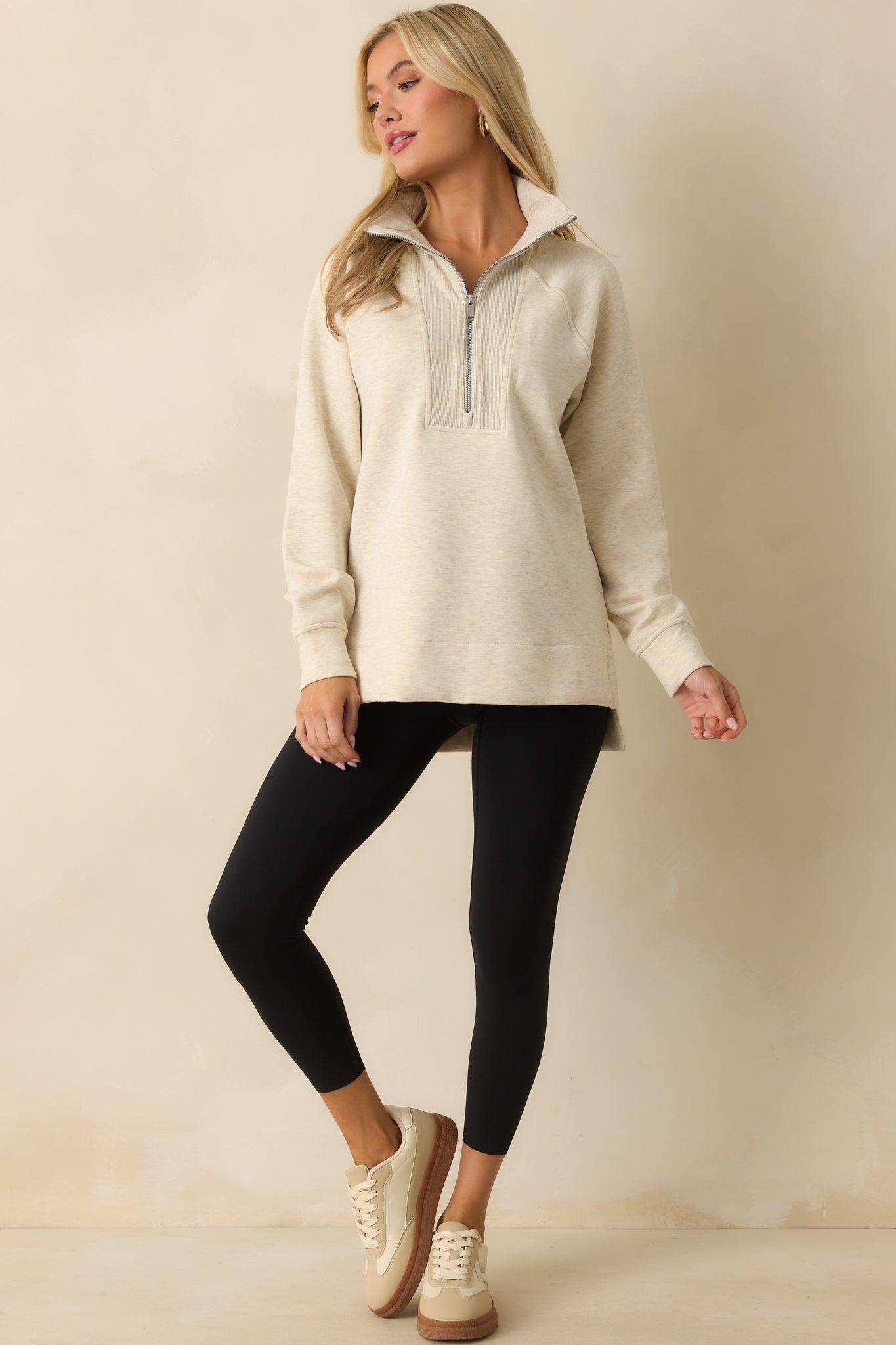Tunic-length ivory pullover crafted from soft brushed performance knit.