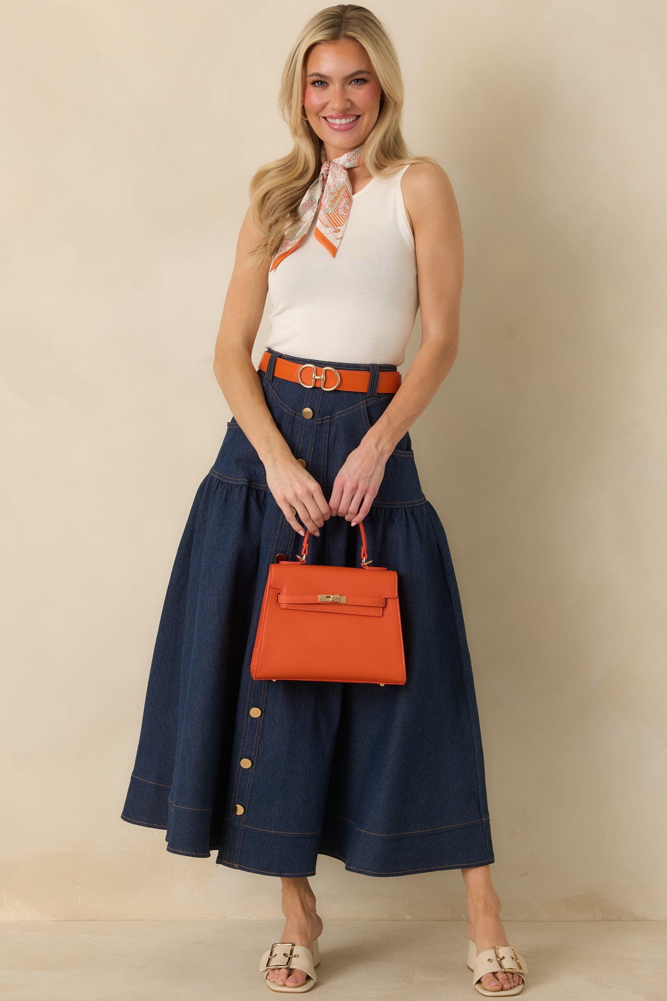 Full-length front view of the ivory ribbed tank top highlighting the fitted silhouette and round neckline.