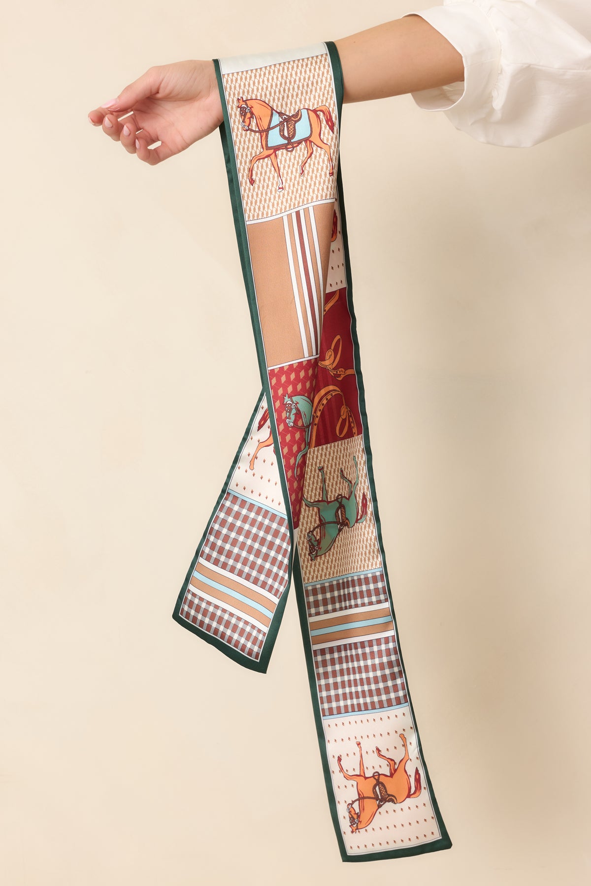 Ivory and rust patchwork scarf accented by forest green edging and detailed equestrian patterns.