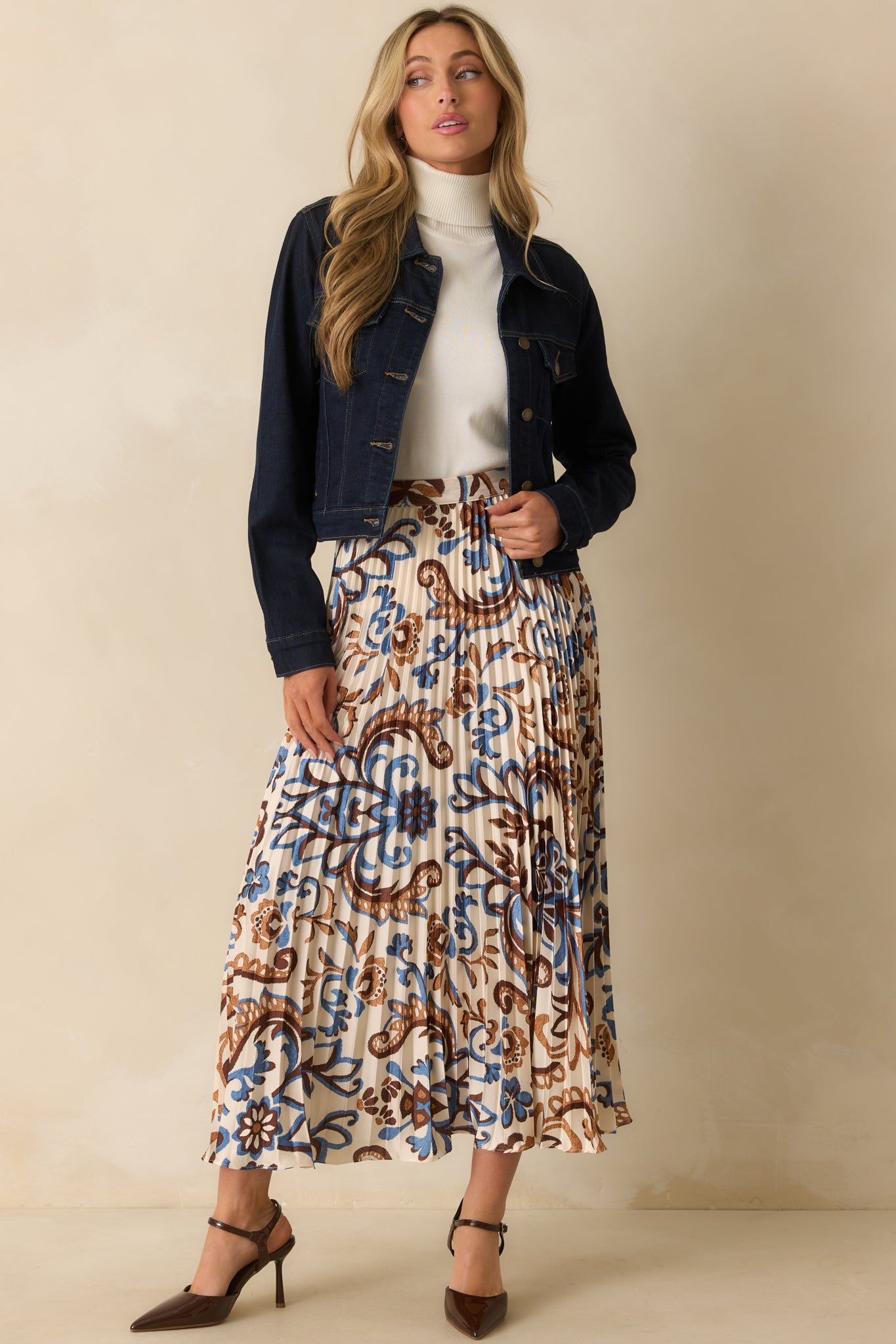 Ivory satin maxi skirt with blue and brown paisley floral print and pleated design.