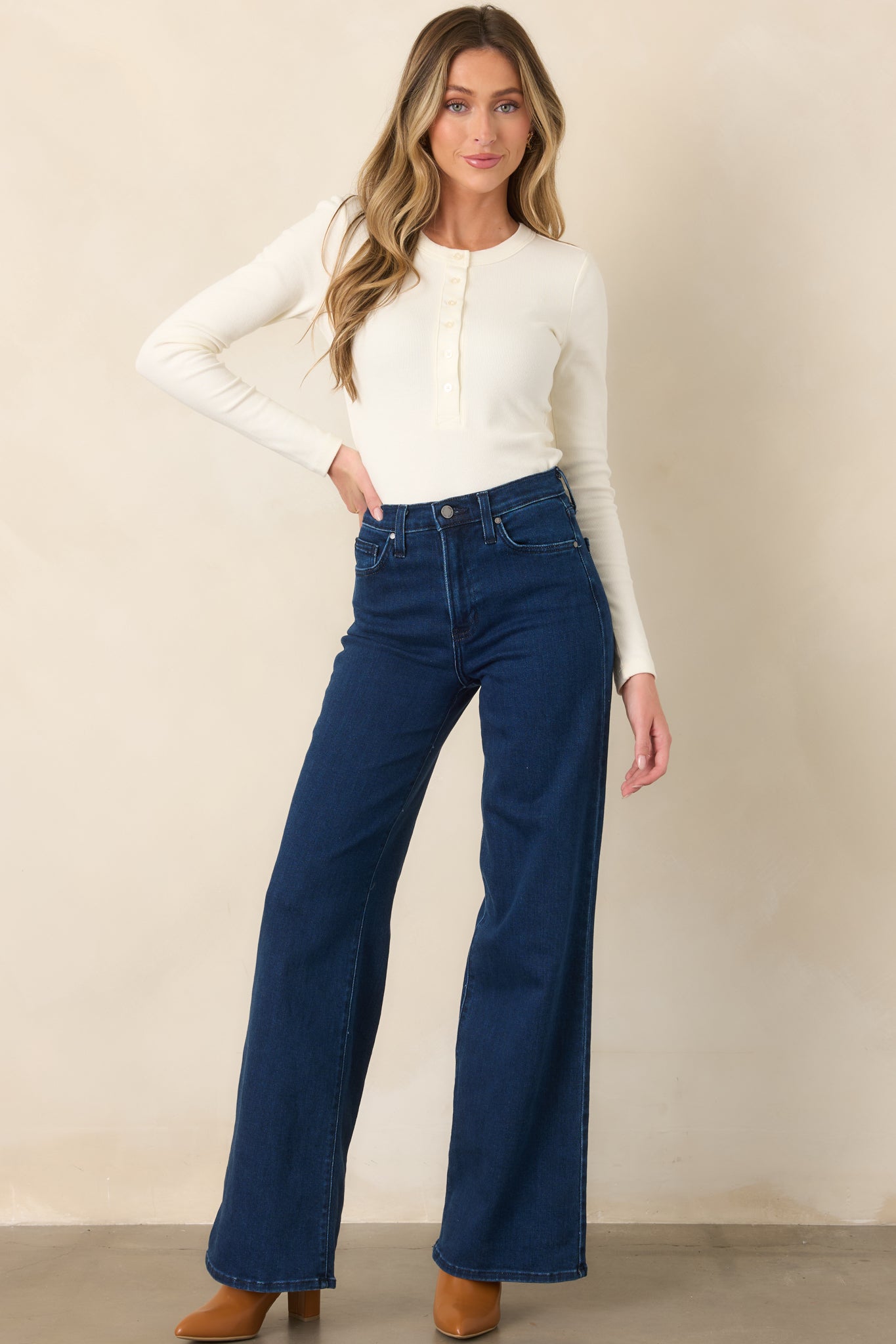 Ivory Henley top with a soft scoop neckline, functional button-front placket, long sleeves, and a cropped length that sits at the waist.