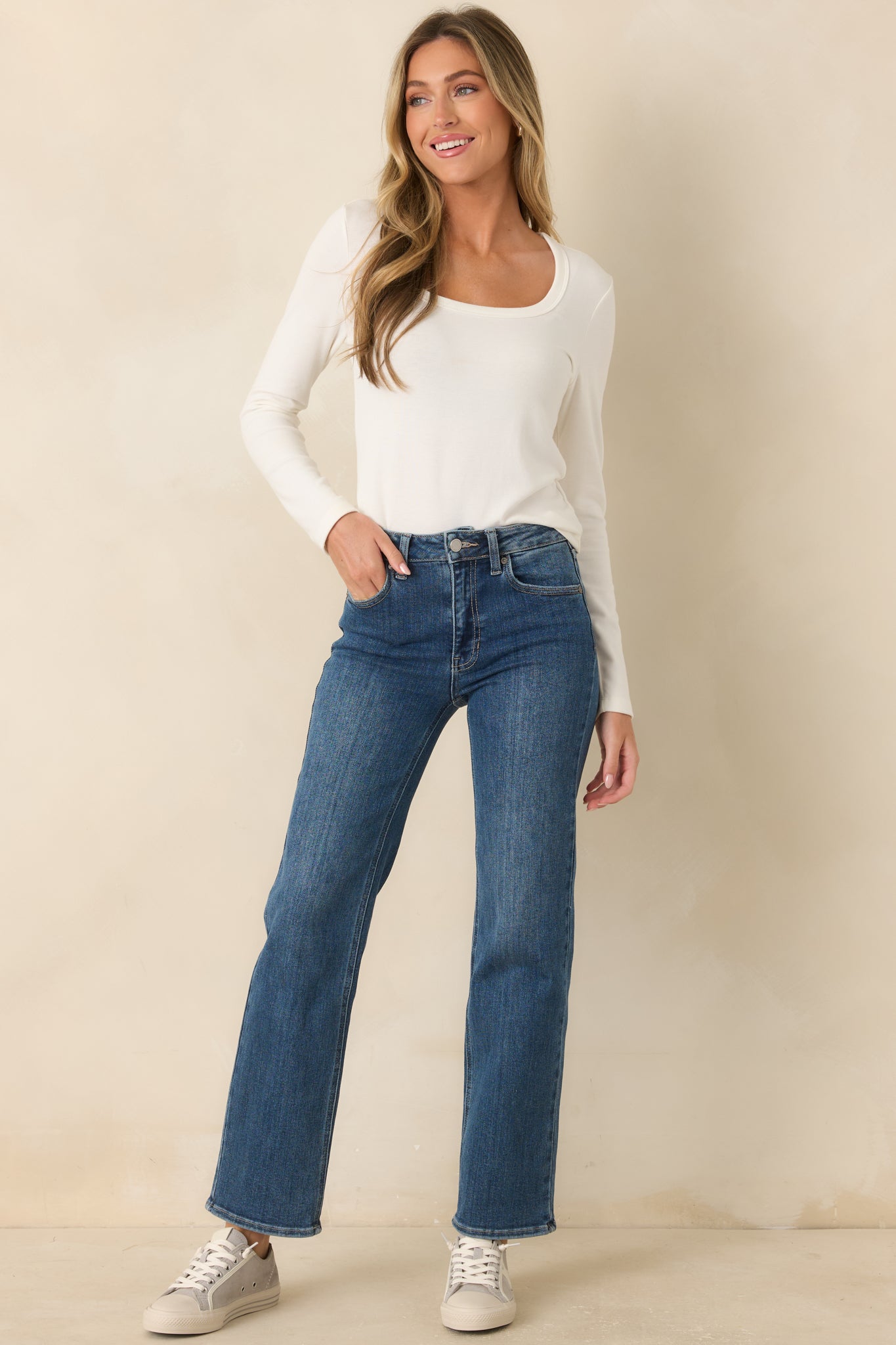Ivory long sleeve top featuring a scoop neckline, slightly fitted silhouette, and soft everyday design.