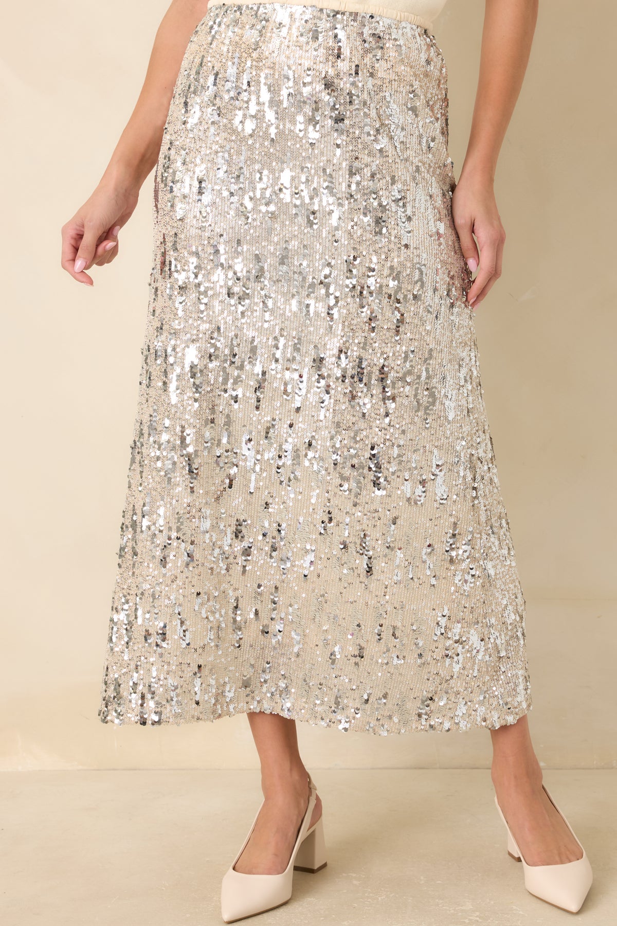 Gently flared midi skirt with a sparkling sequin exterior and softly draped hemline.