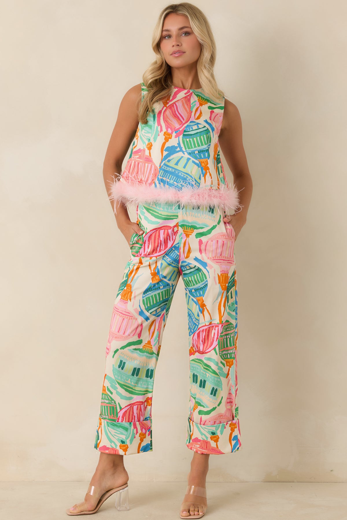Ivory statement pants with oversized colorful ornaments and a relaxed wide-leg silhouette.