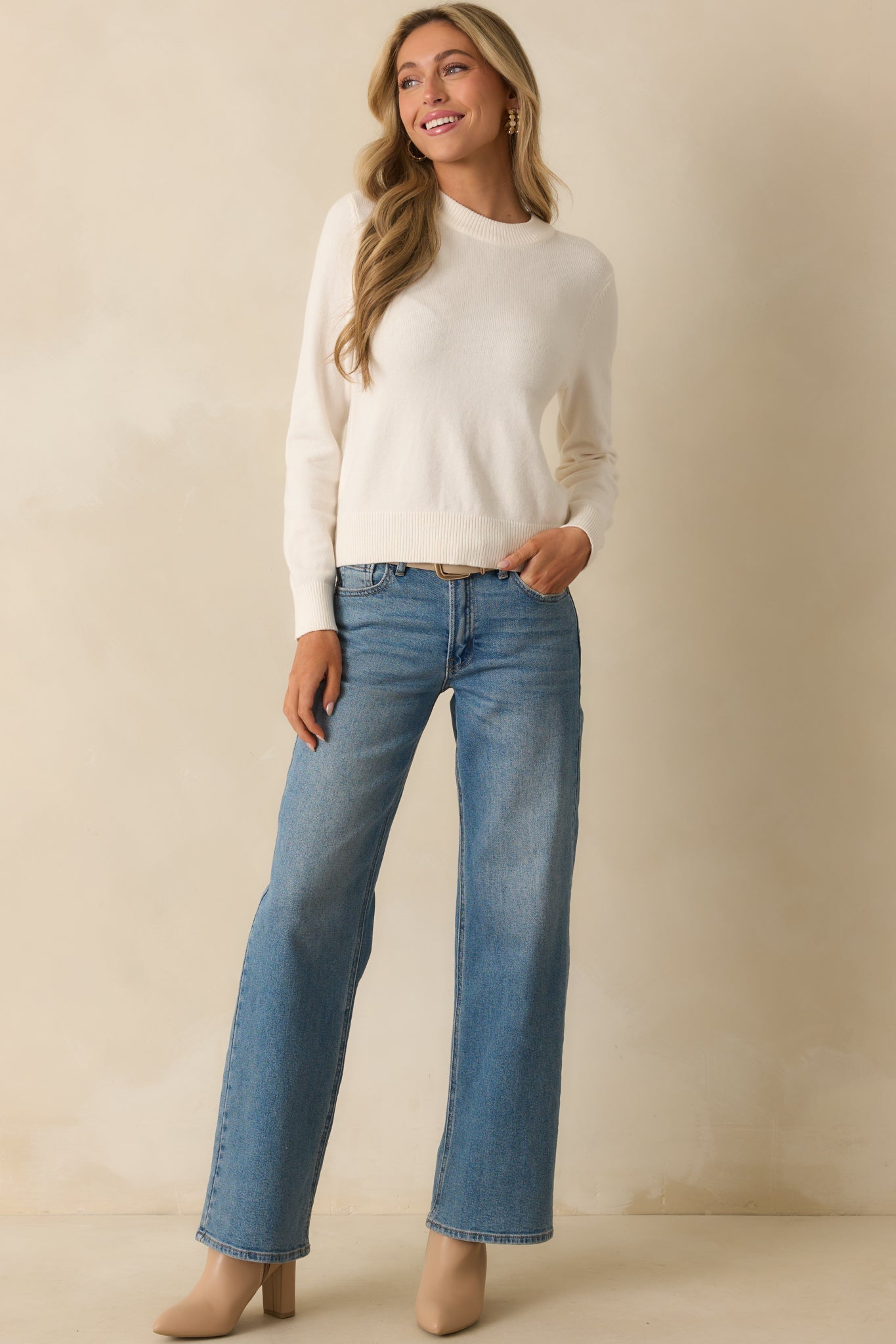 Ivory sweater with a classic crew neckline and long sleeves.