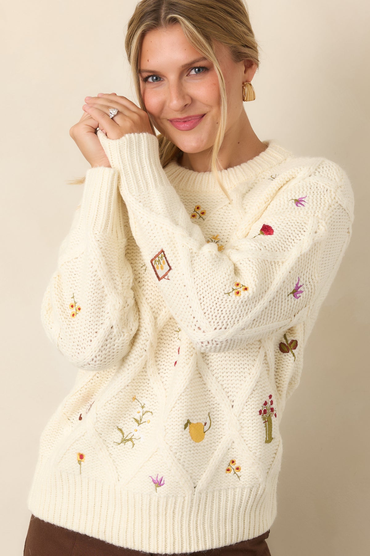 Textured ivory top with scattered garden-inspired embroidery, including colorful flowers, berries, and fruit motifs.