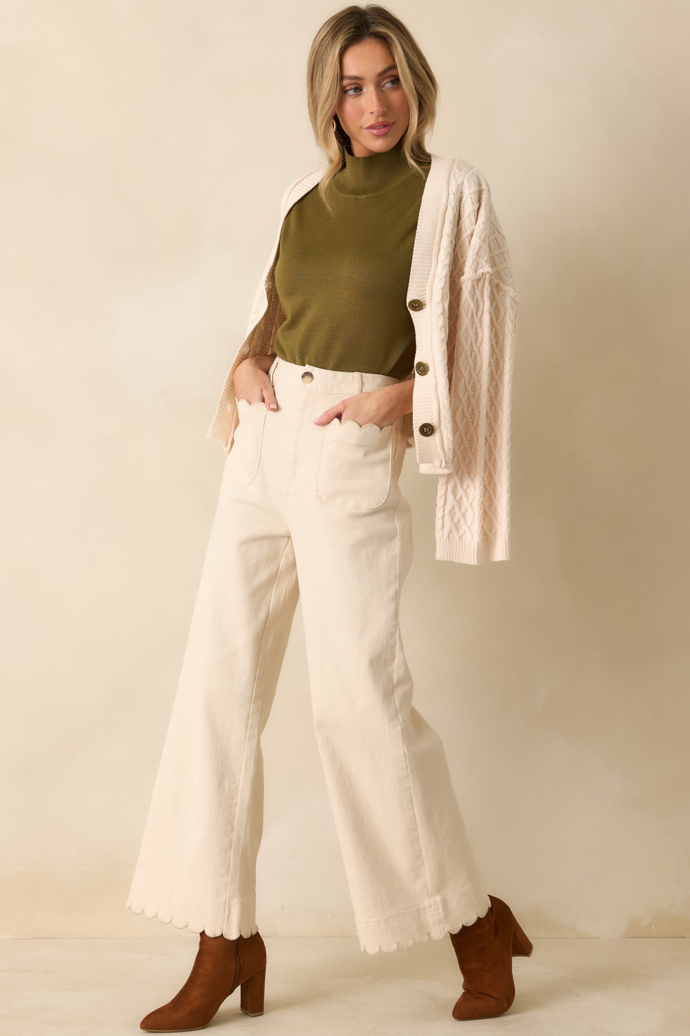 Ivory wide-leg pants featuring high-rise fit, clean lines, and subtle scalloped details at pockets and hem.