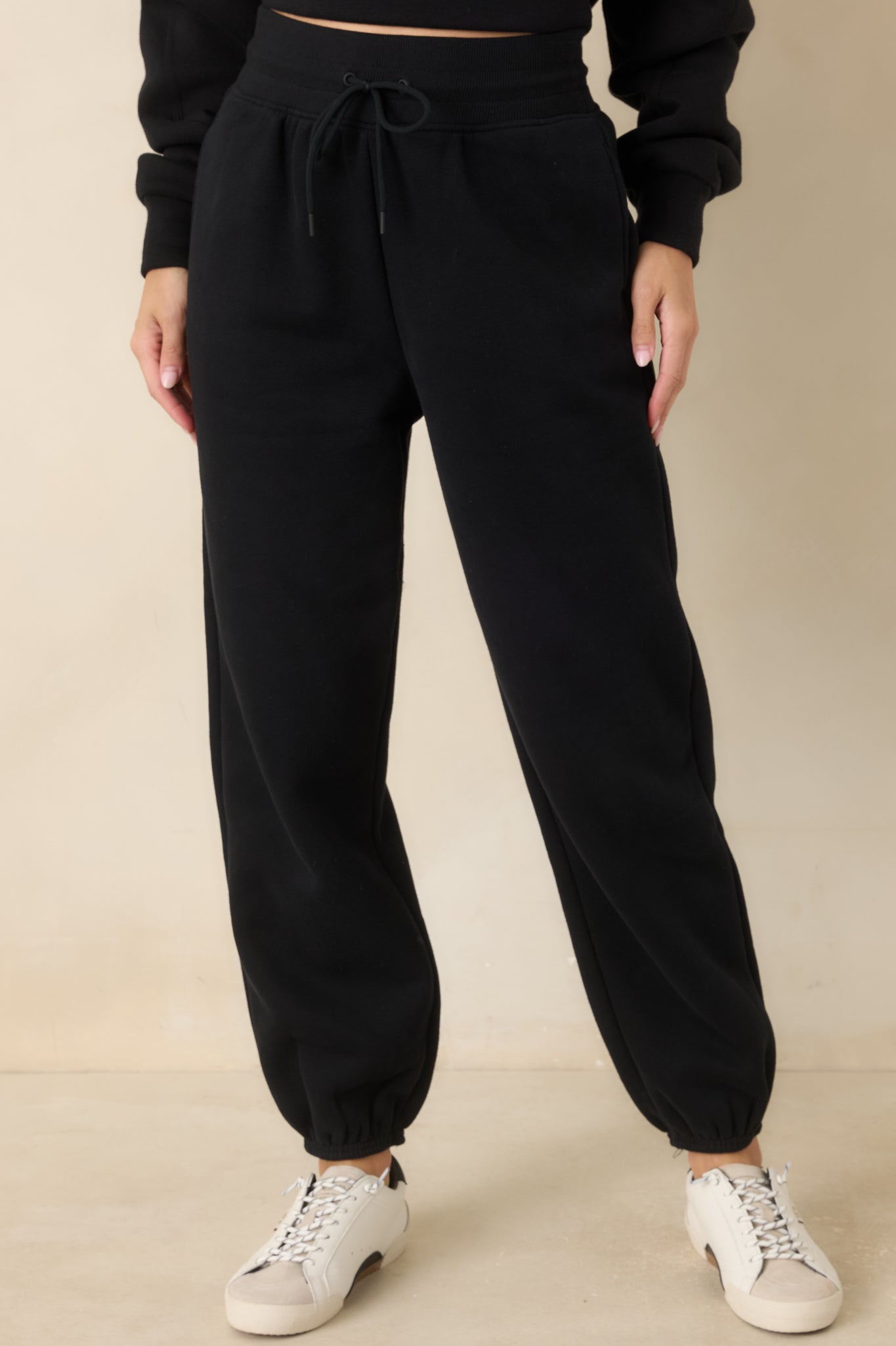 Detailed view of the jogger pants featuring side pockets, a relaxed upper fit, and tapered leg construction.