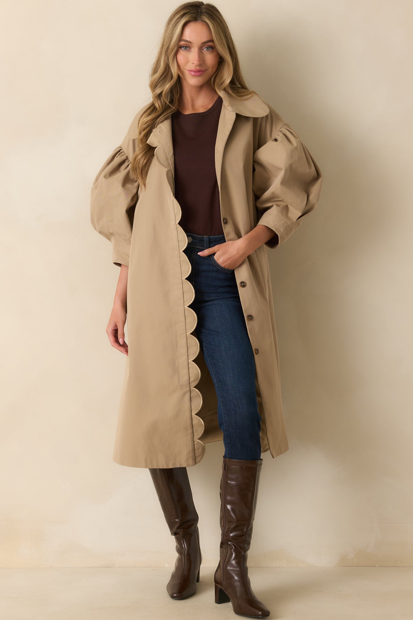 Long khaki coat featuring side seam pockets and a loose, easy fit.