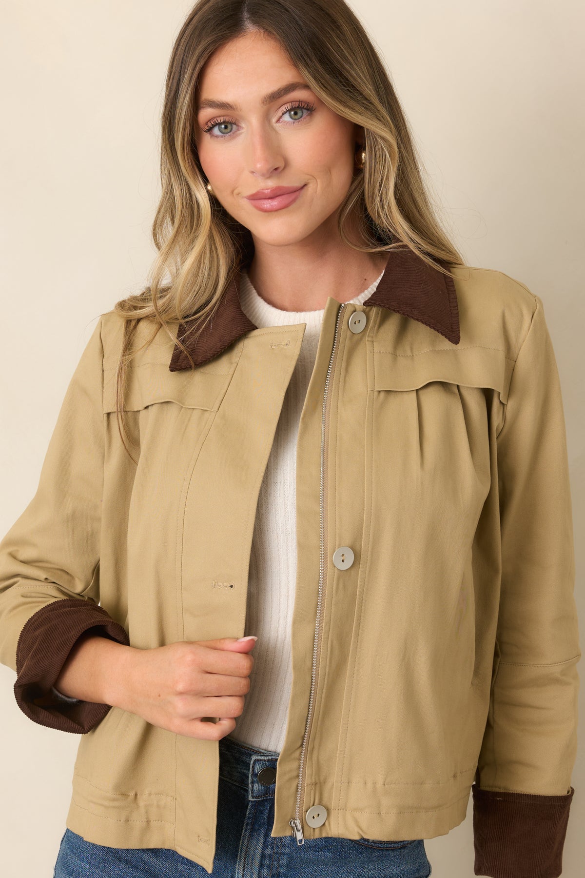 Soft stretch cotton-blend jacket highlighting its clean khaki finish and contrasting brown collar texture.