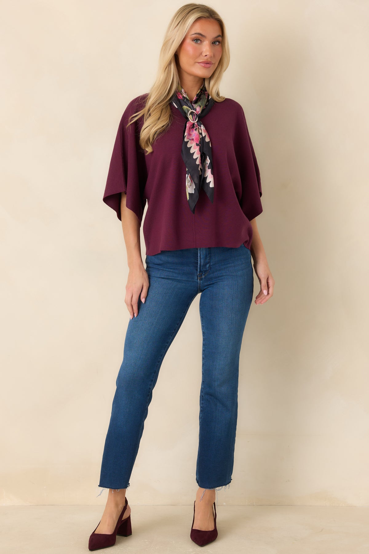 Relaxed knit poncho top with a wide round neckline, elbow-length sleeves, and a center-front seam.