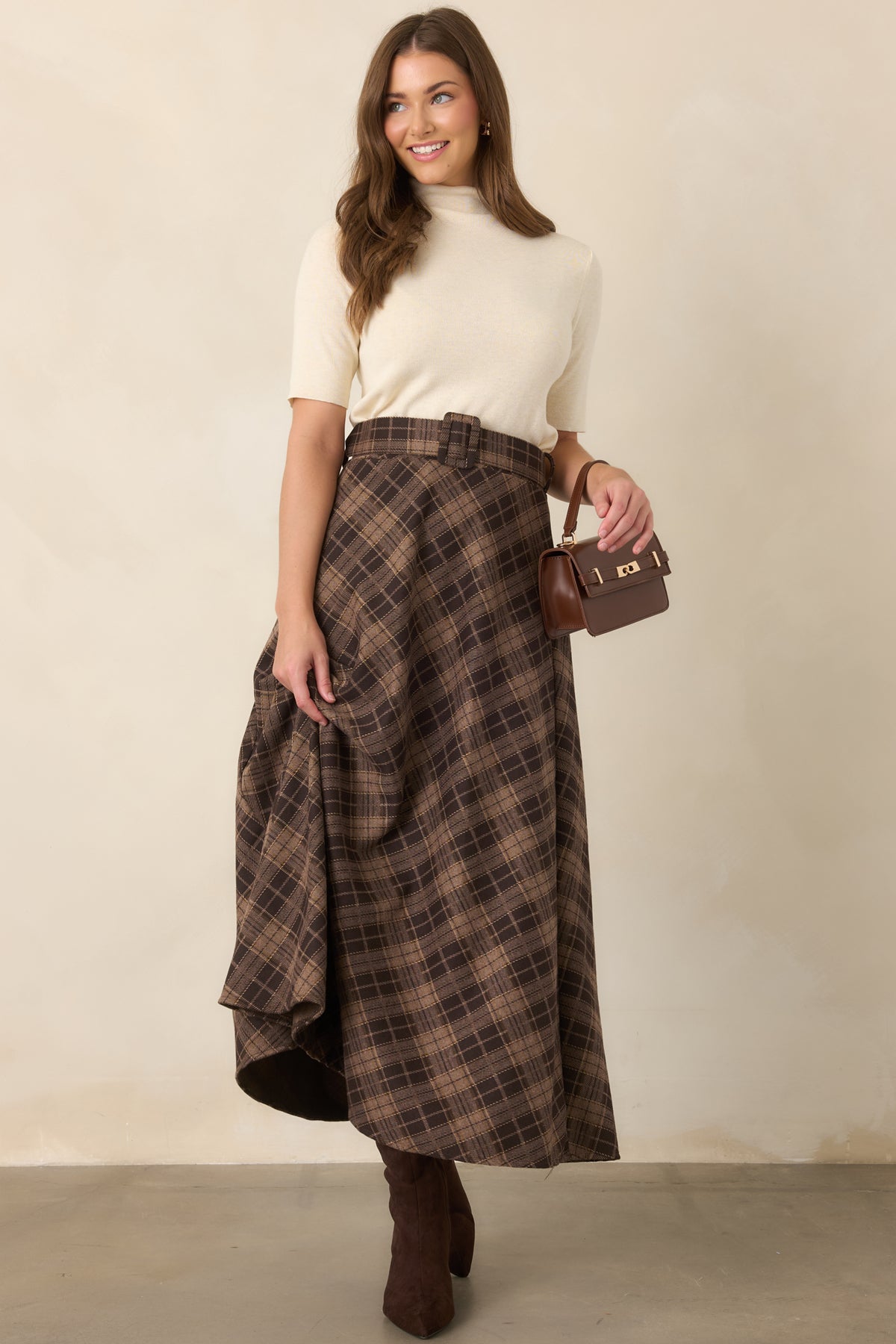 Short sleeve knit top showcasing its simple silhouette and high turtleneck neckline for a polished finish.