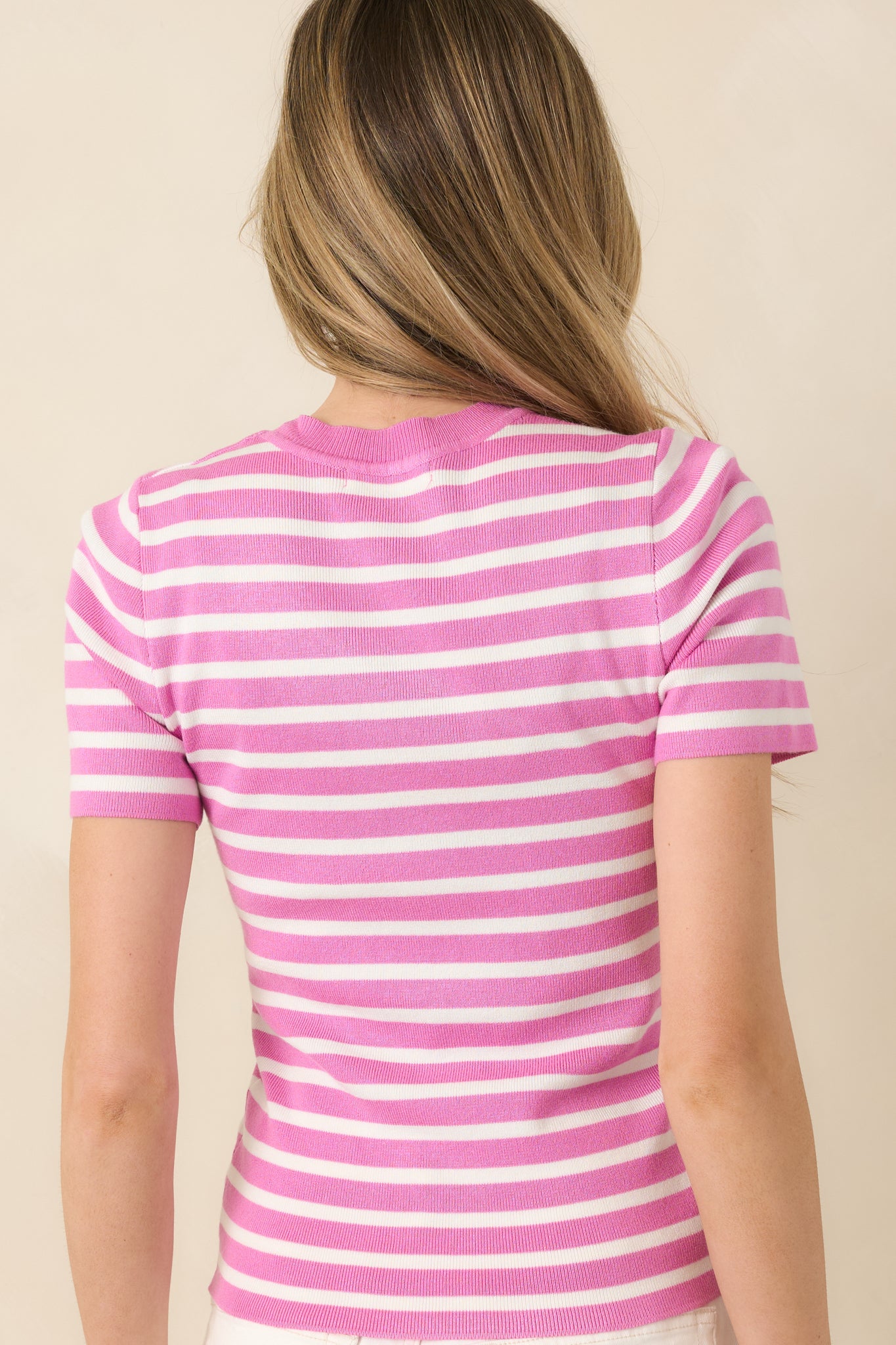 Knit top with orchid pink and ivory stripe pattern and short sleeves.
