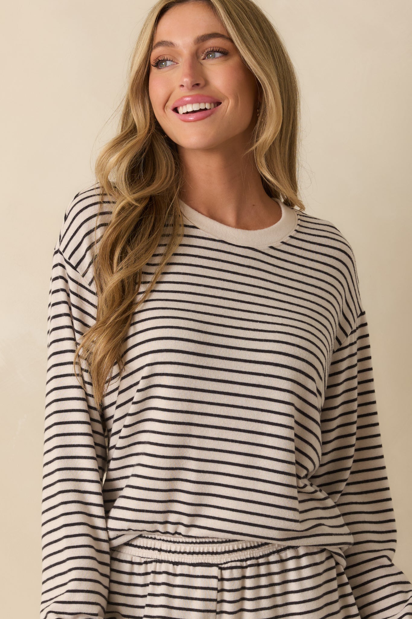 Detail of the soft knit texture and black stripe pattern on the ivory fabric.