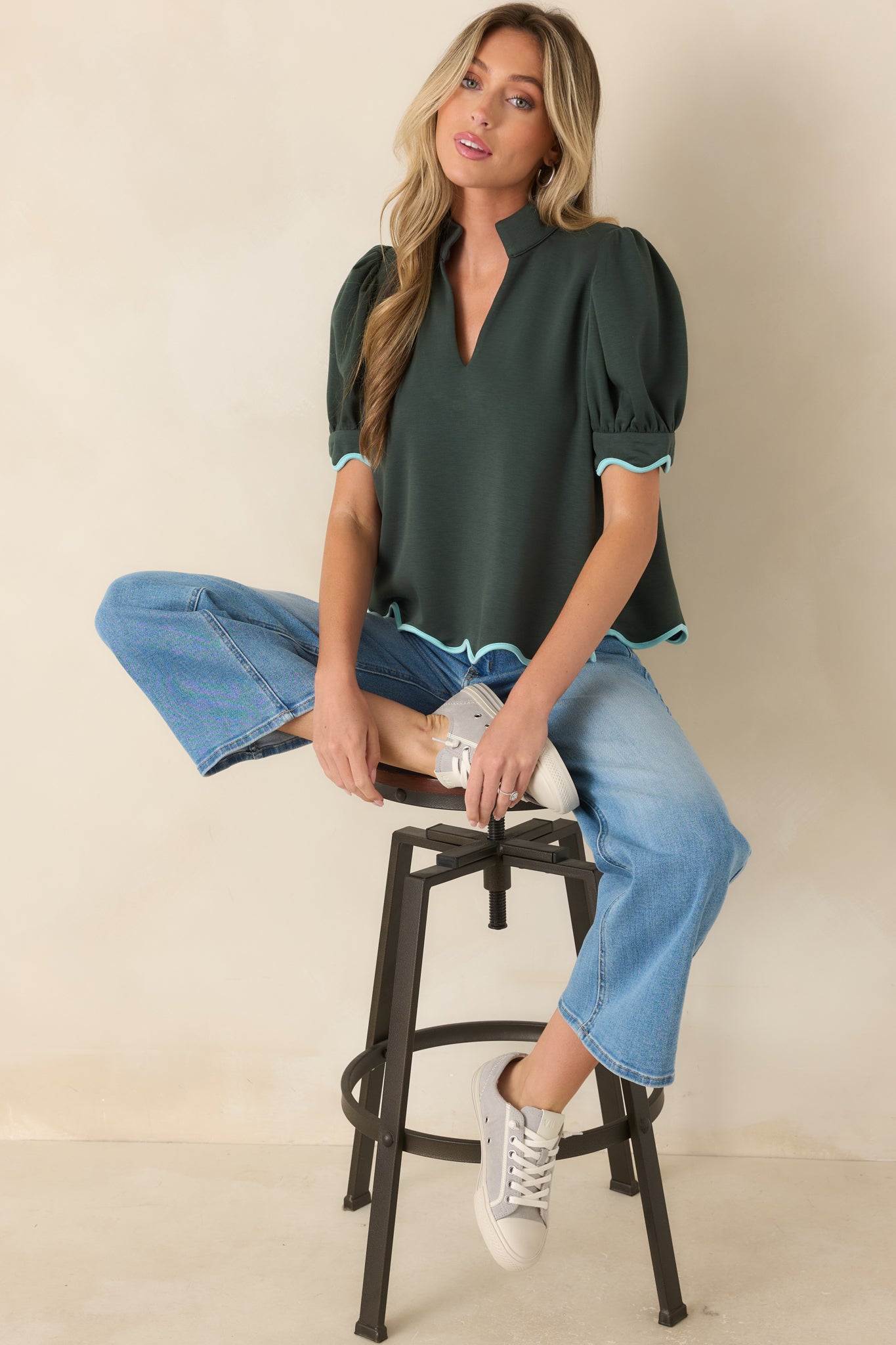 Puff sleeves with light blue scalloped trim add a feminine detail to this knit top.