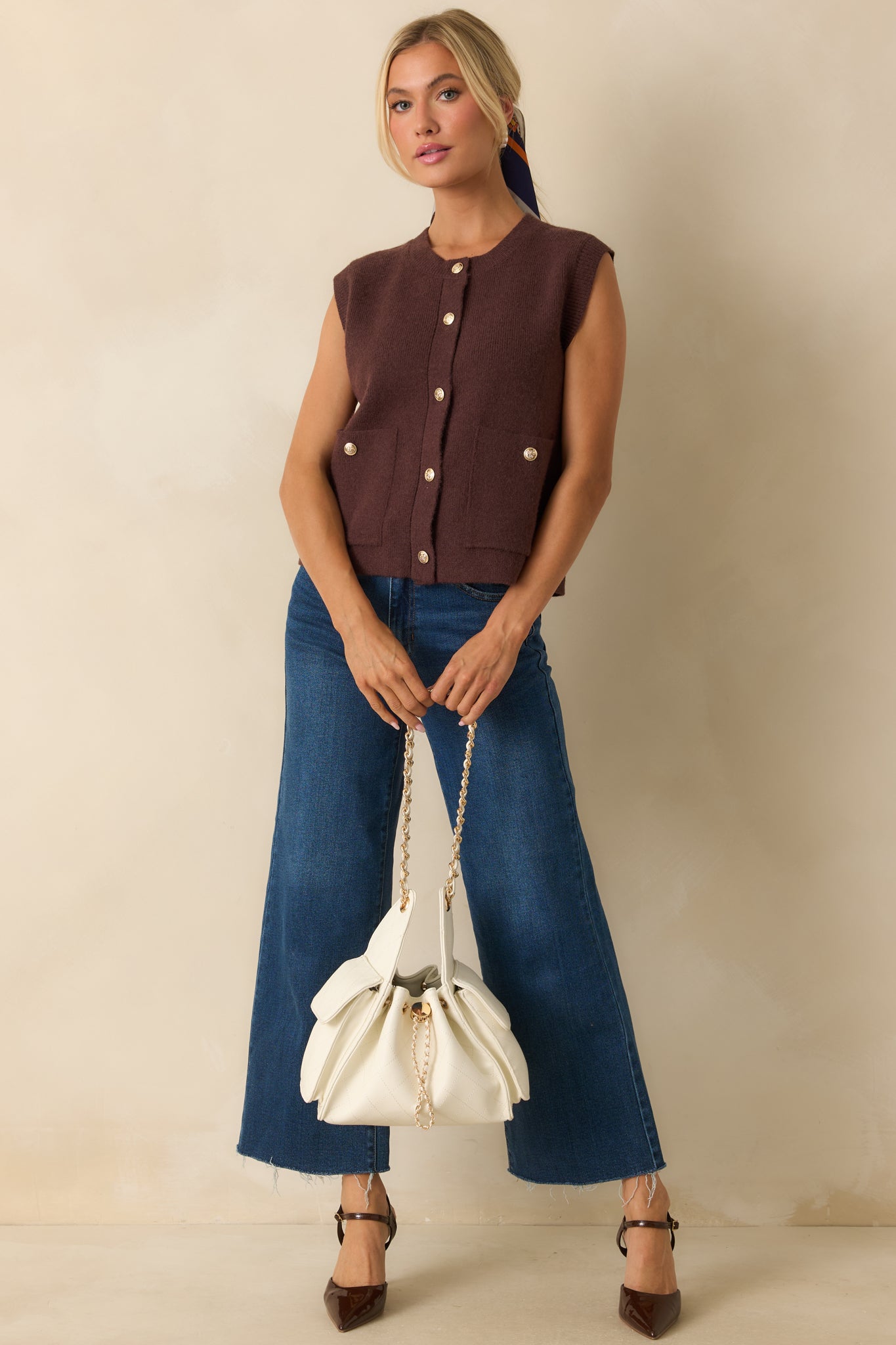 Knit vest styled to highlight the relaxed fit, patch pockets, and smooth fabric drape.