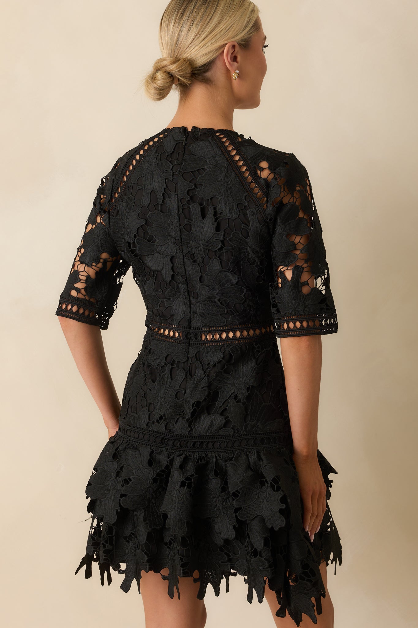 Rear view of the lace mini dress featuring scalloped edges and hidden zipper closure.