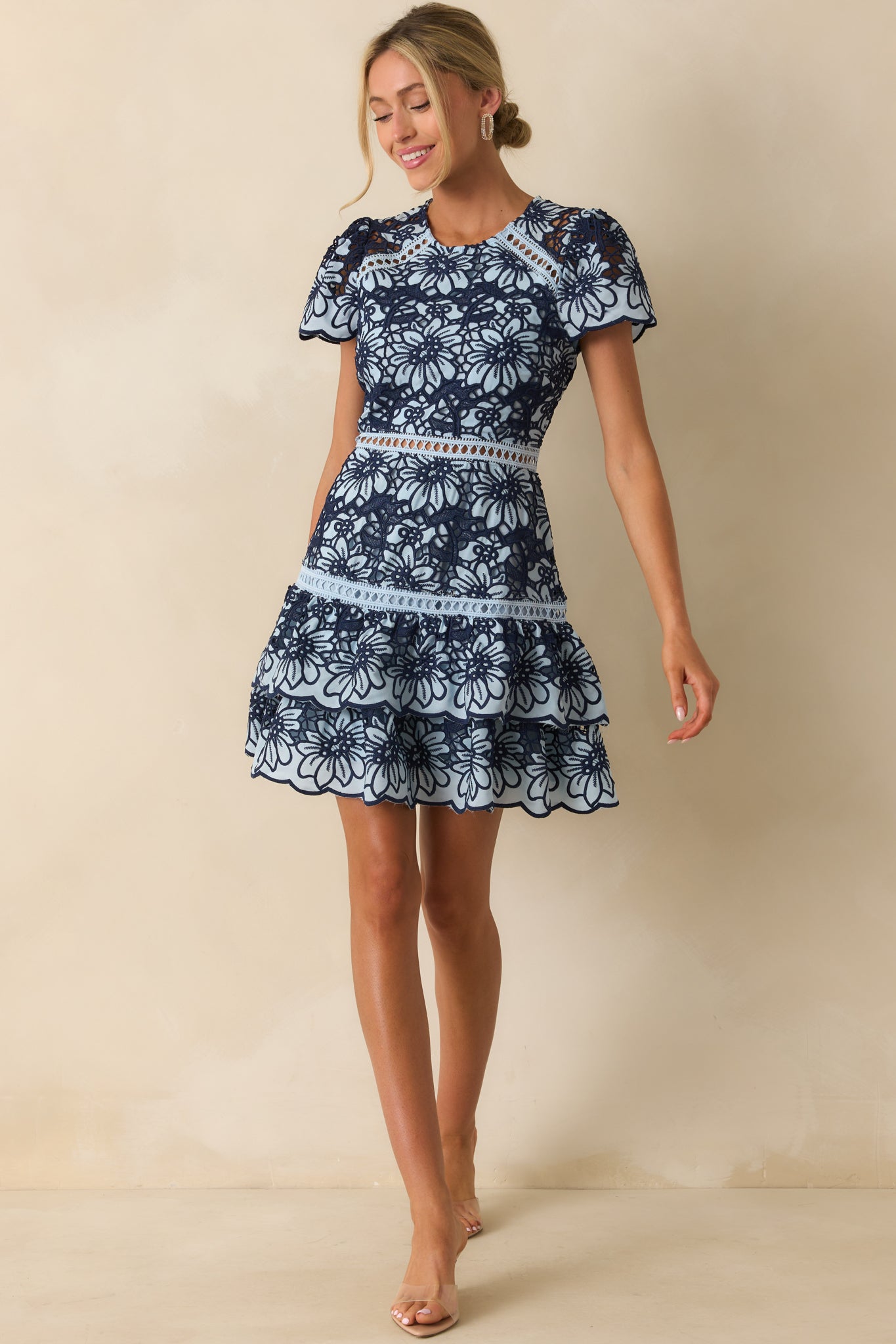 Lace overlay dress with puff sleeves, fitted bodice, and playful ruffled hemline.