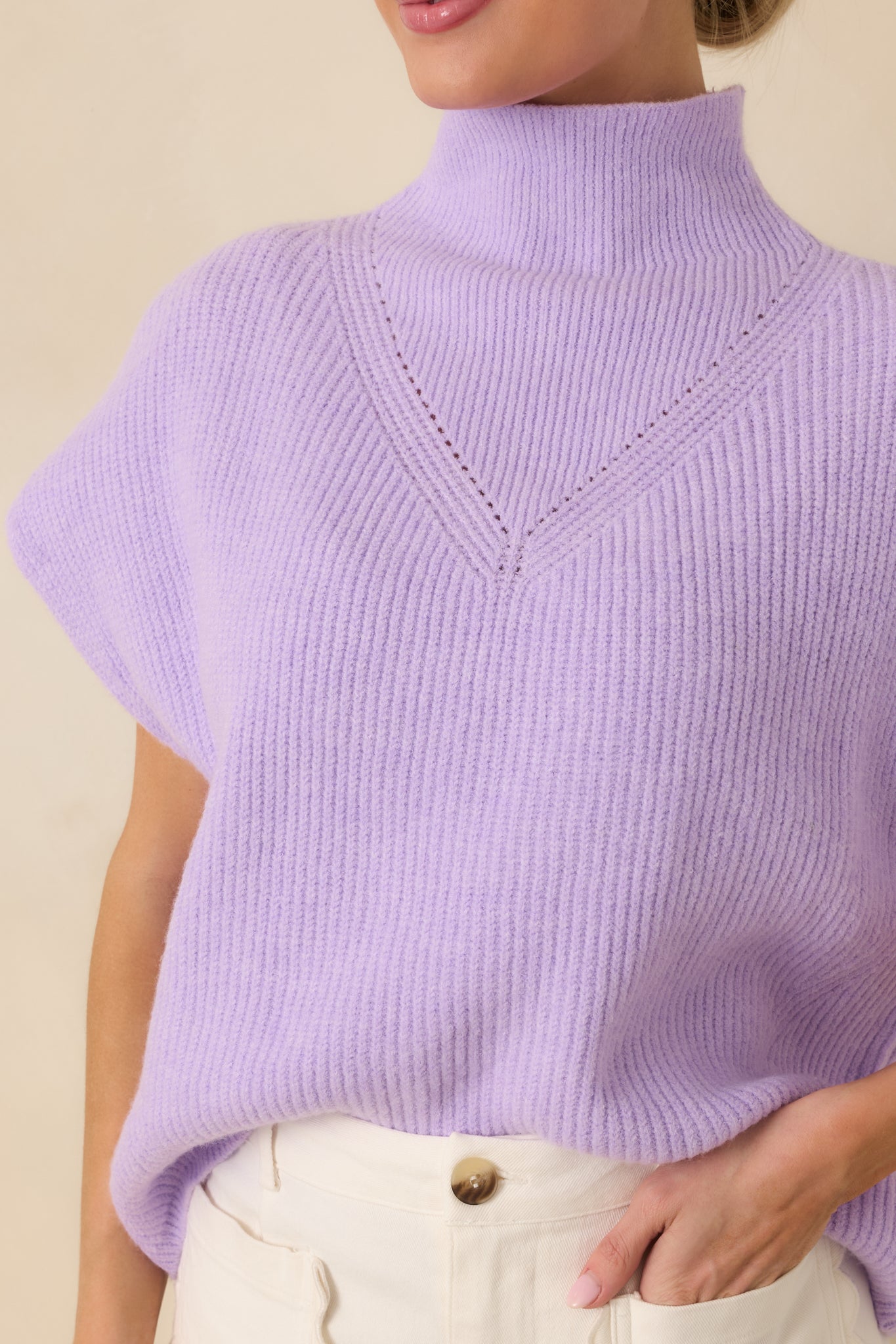 Lavender ribbed knit fabric with mock neckline and delicate chest detailing.