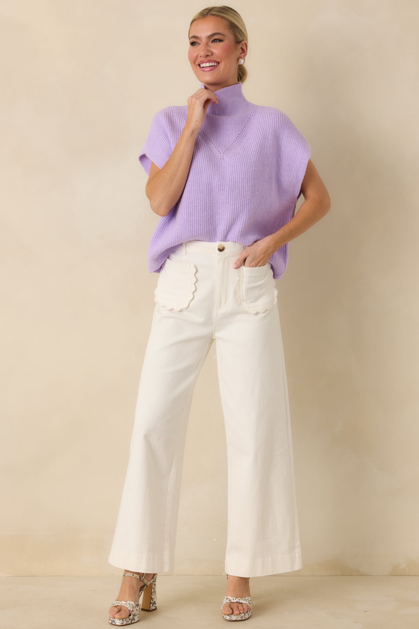 Lavender knit sleeveless sweater with clean hem and soft ribbed texture.