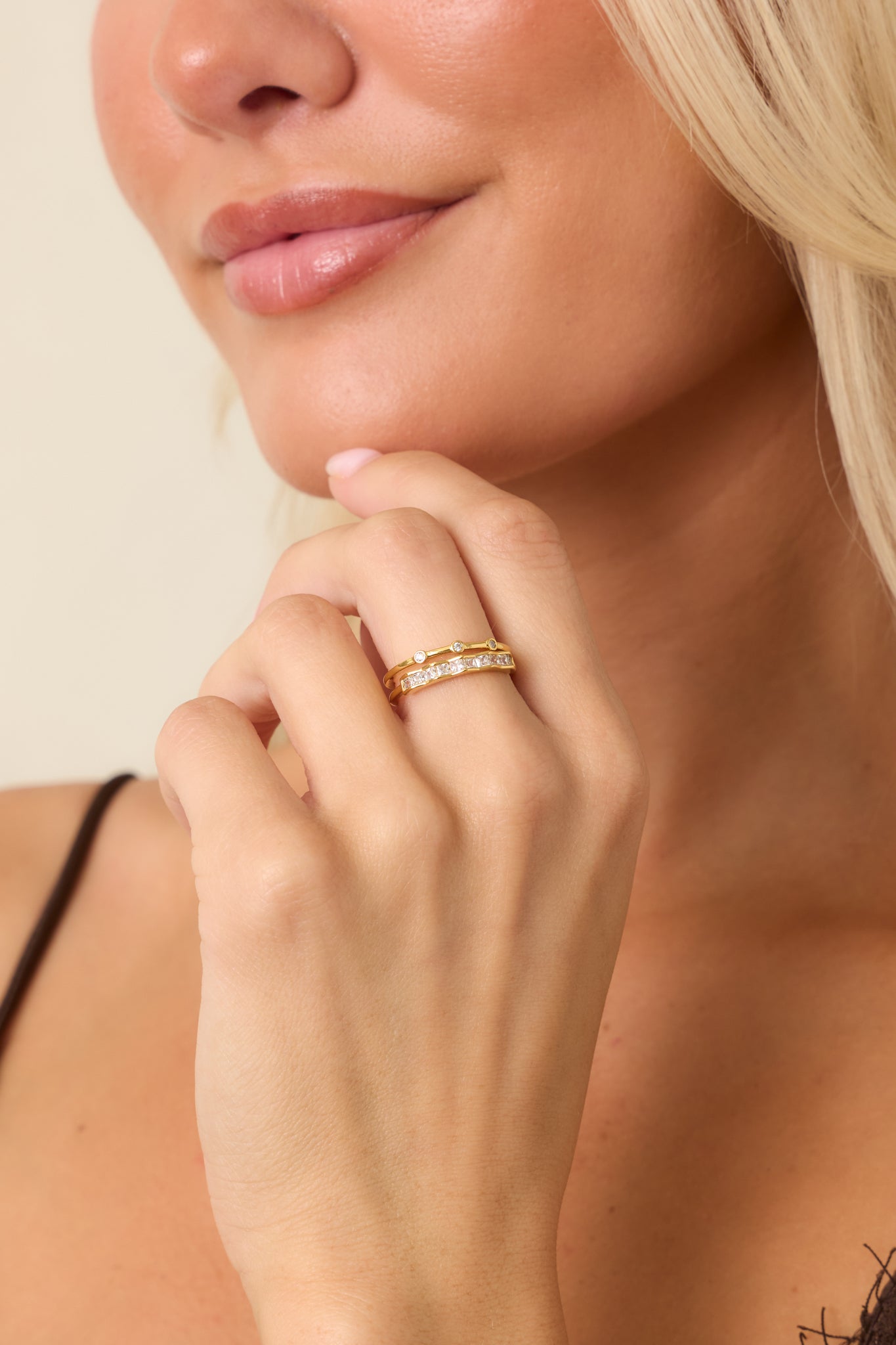 Layered gold ring with one crystal-accented band, one bezel-set stone band, and an adjustable open-back design.