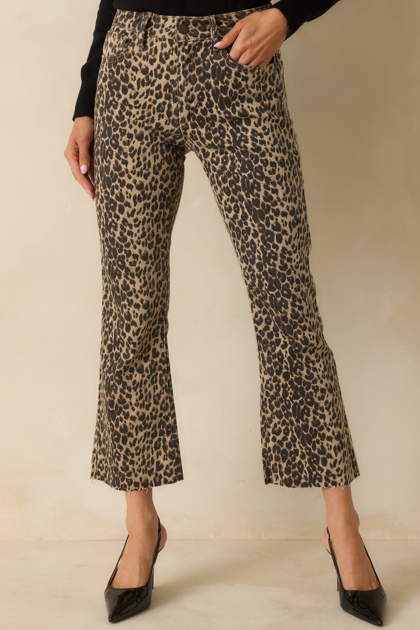Leopard print cropped flare pants with high-rise waist, front and back pockets, and button-zip closure.