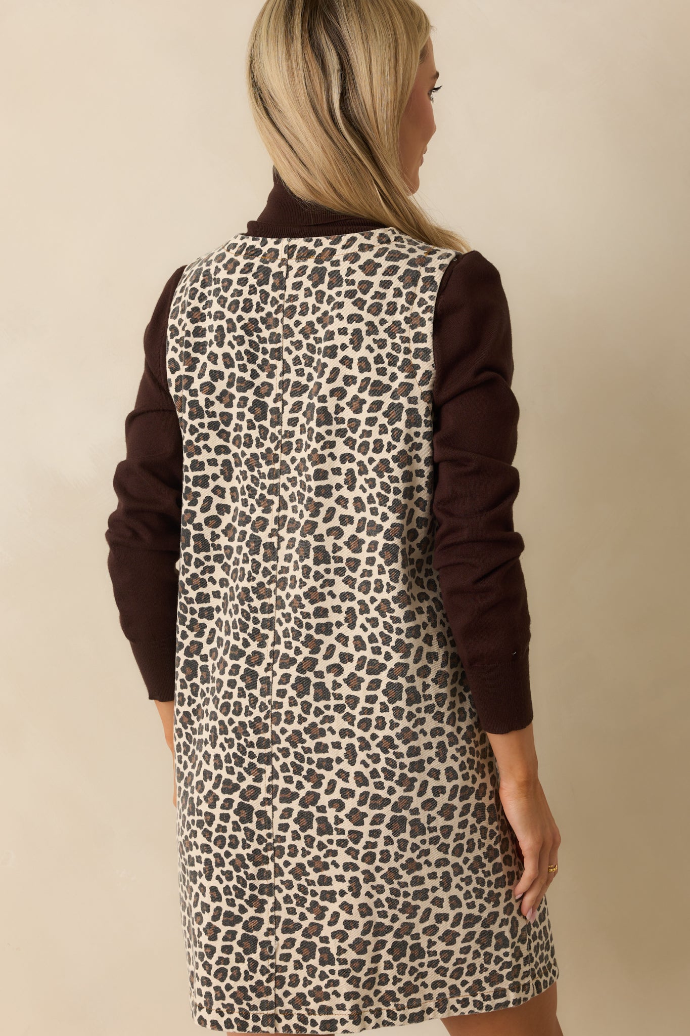 Leopard print denim mini dress with a visible center seam down the rear.
