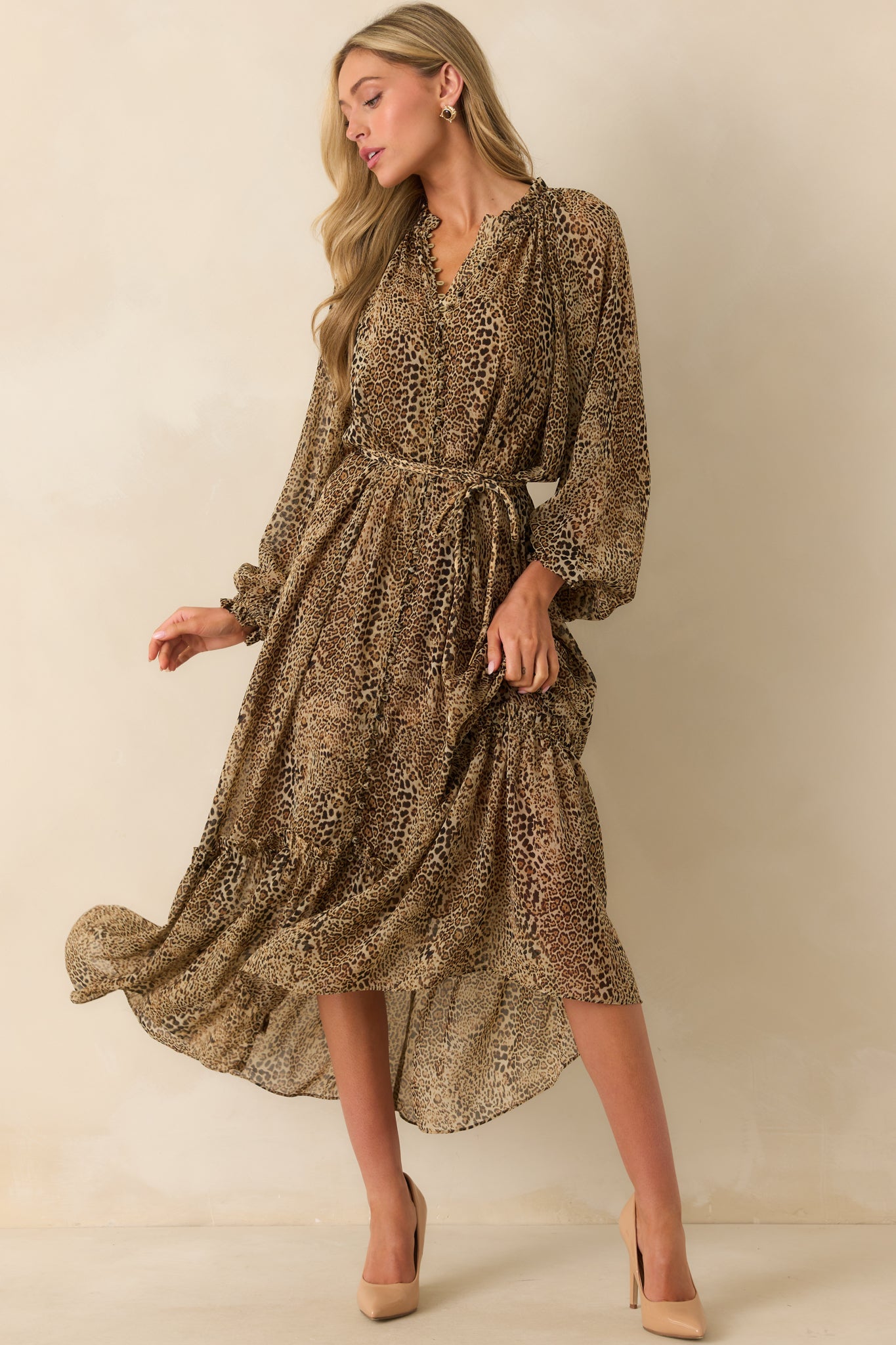 Leopard print maxi dress with long sleeves, ruffle trim detailing, and functional button-front closure.