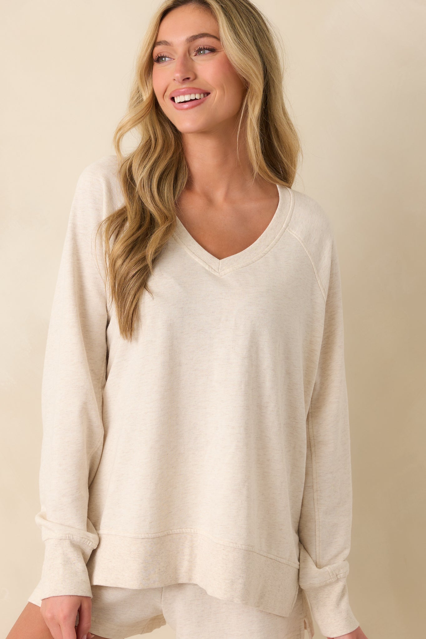 Cropped view focusing on the neckline and upper chest area of the sweatshirt, showing the soft cotton texture.