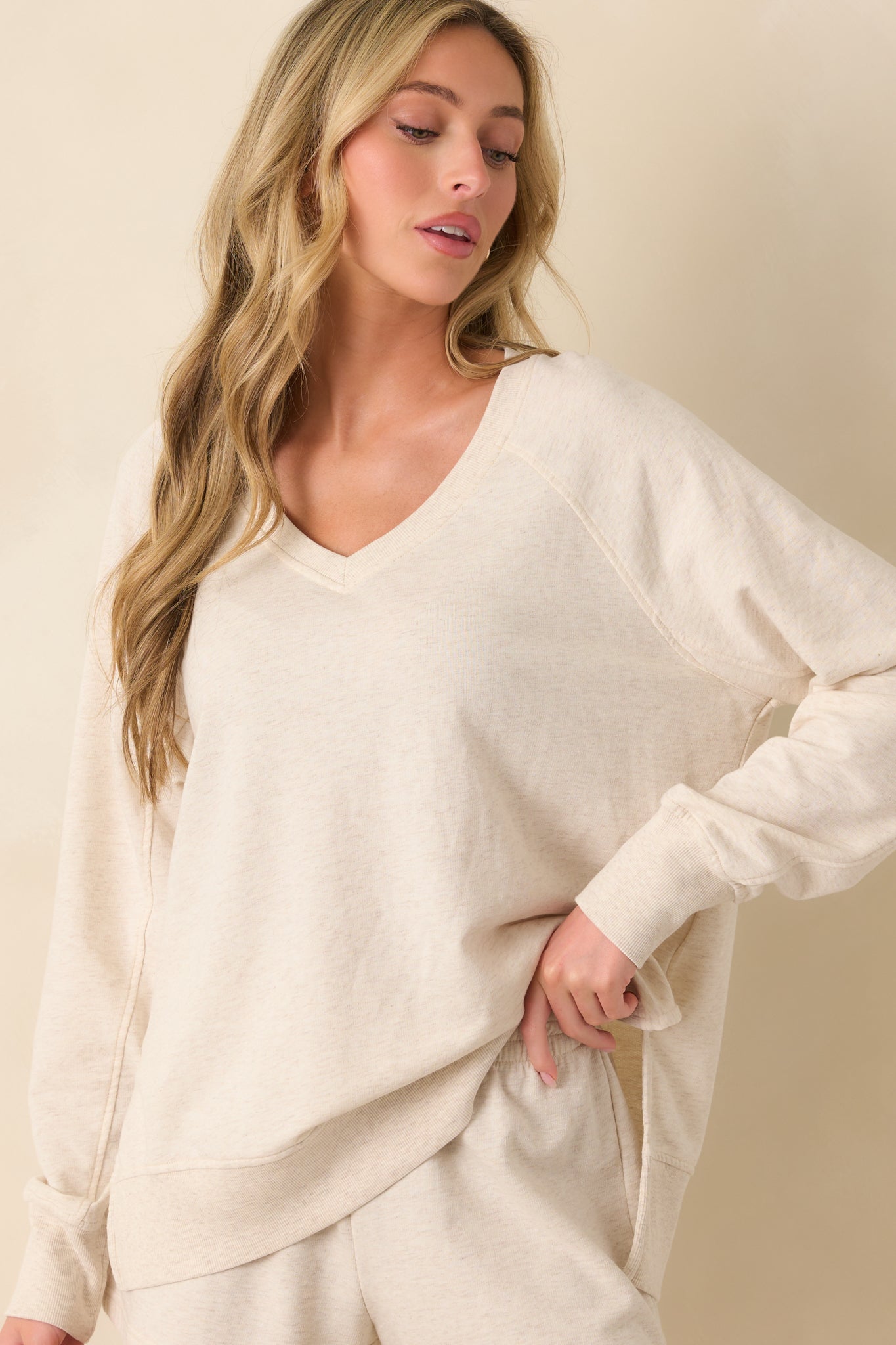 Front full body photo displaying the sweatshirt’s casual drape and subtle side vent slits at the hem.