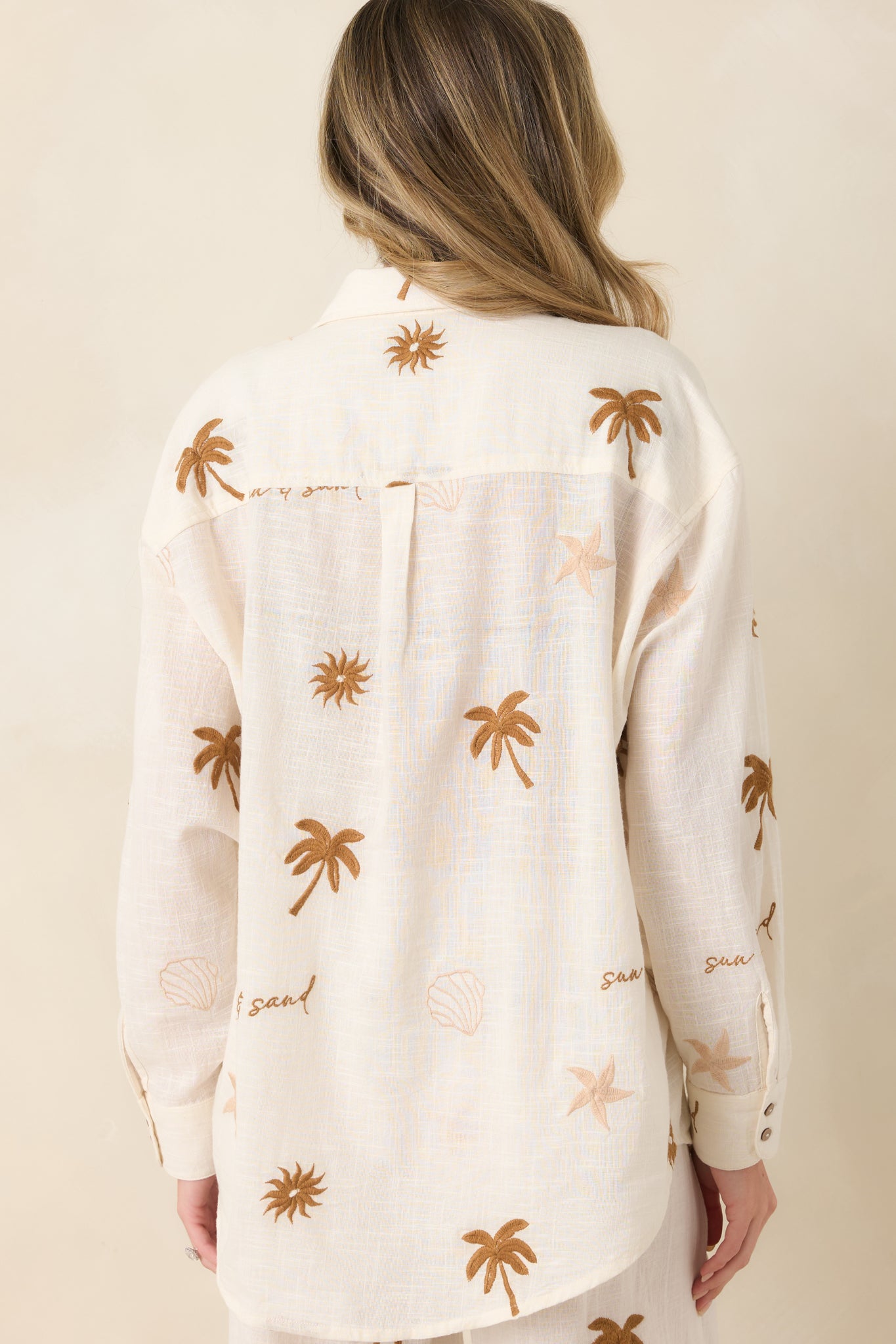 Light beige cotton top with smooth rear finish and relaxed fit.