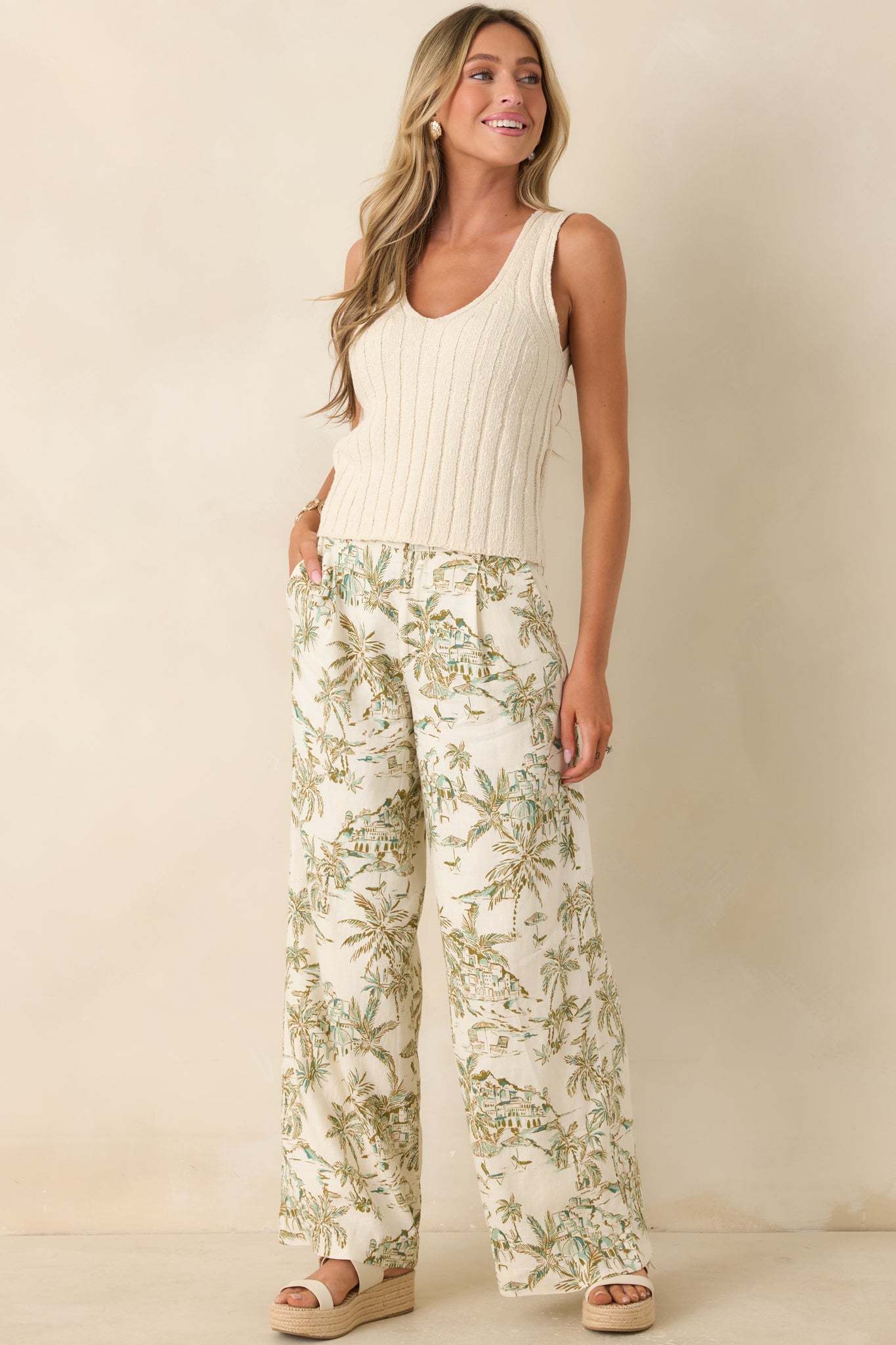 Light beige knit top with a flattering V-neck and streamlined fit.