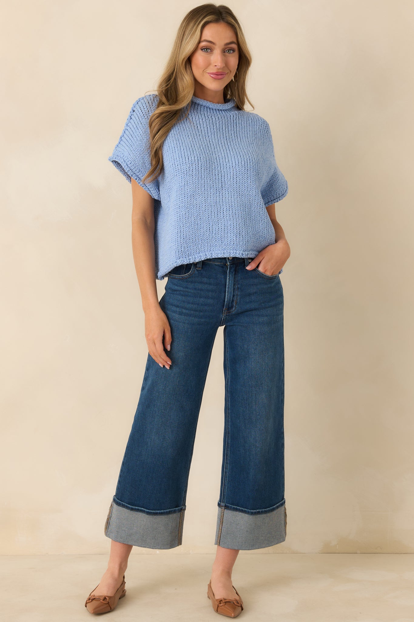 Light blue chunky knit sweater with short sleeves and rolled-edge crew neckline, relaxed casual fit.