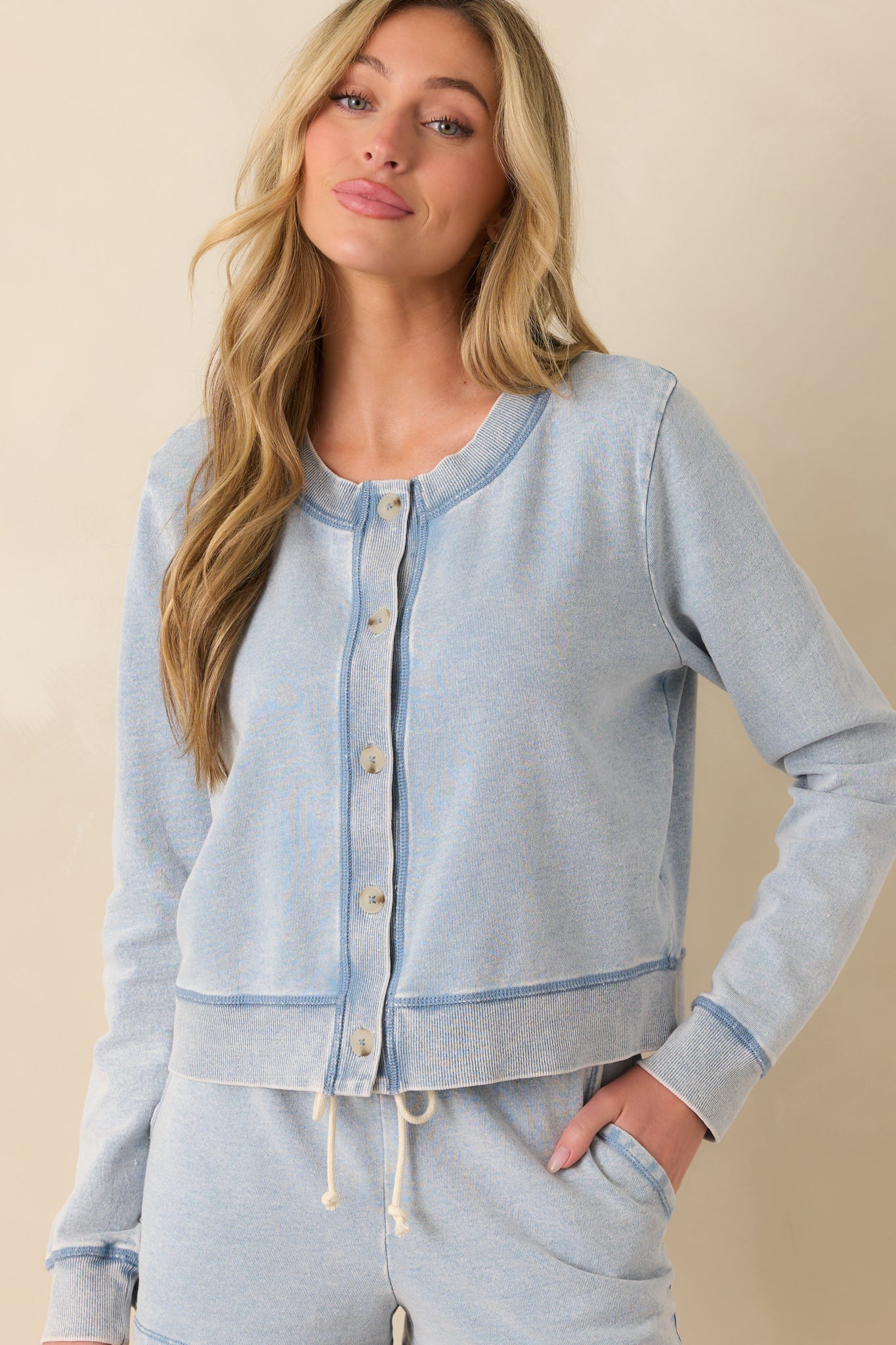 Cropped image of the sleeve and shoulder area, showcasing the long sleeve fit and ribbed wrist hem.
