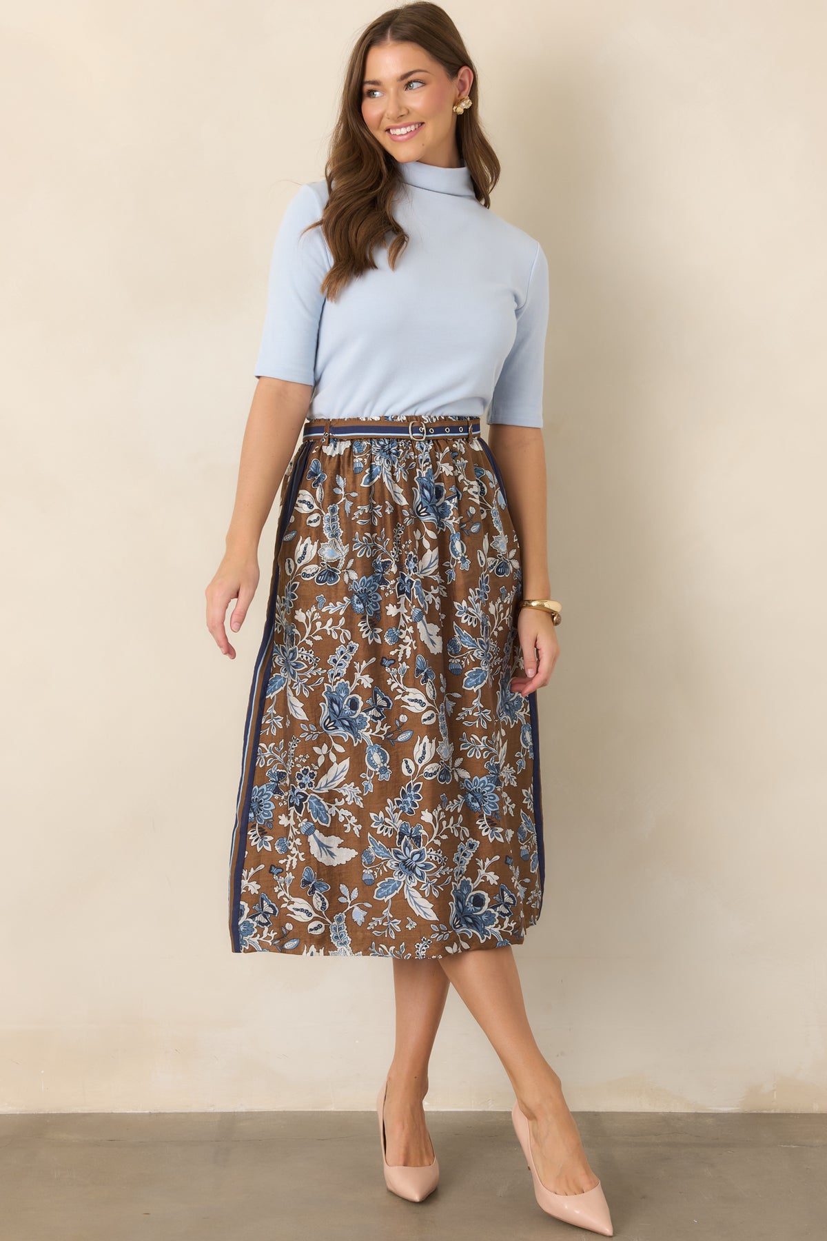 Soft light blue cotton-viscose knit top featuring a refined mock neckline, elbow-length sleeves, gentle stretch, and a softly fitted silhouette.