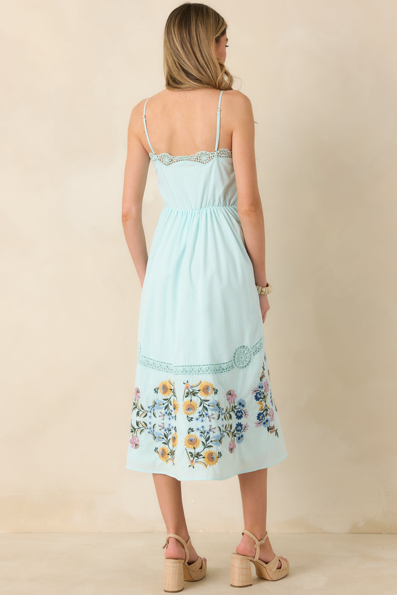 Light blue dress with adjustable straps, ladder lace detailing, and discrete side zipper at the back.