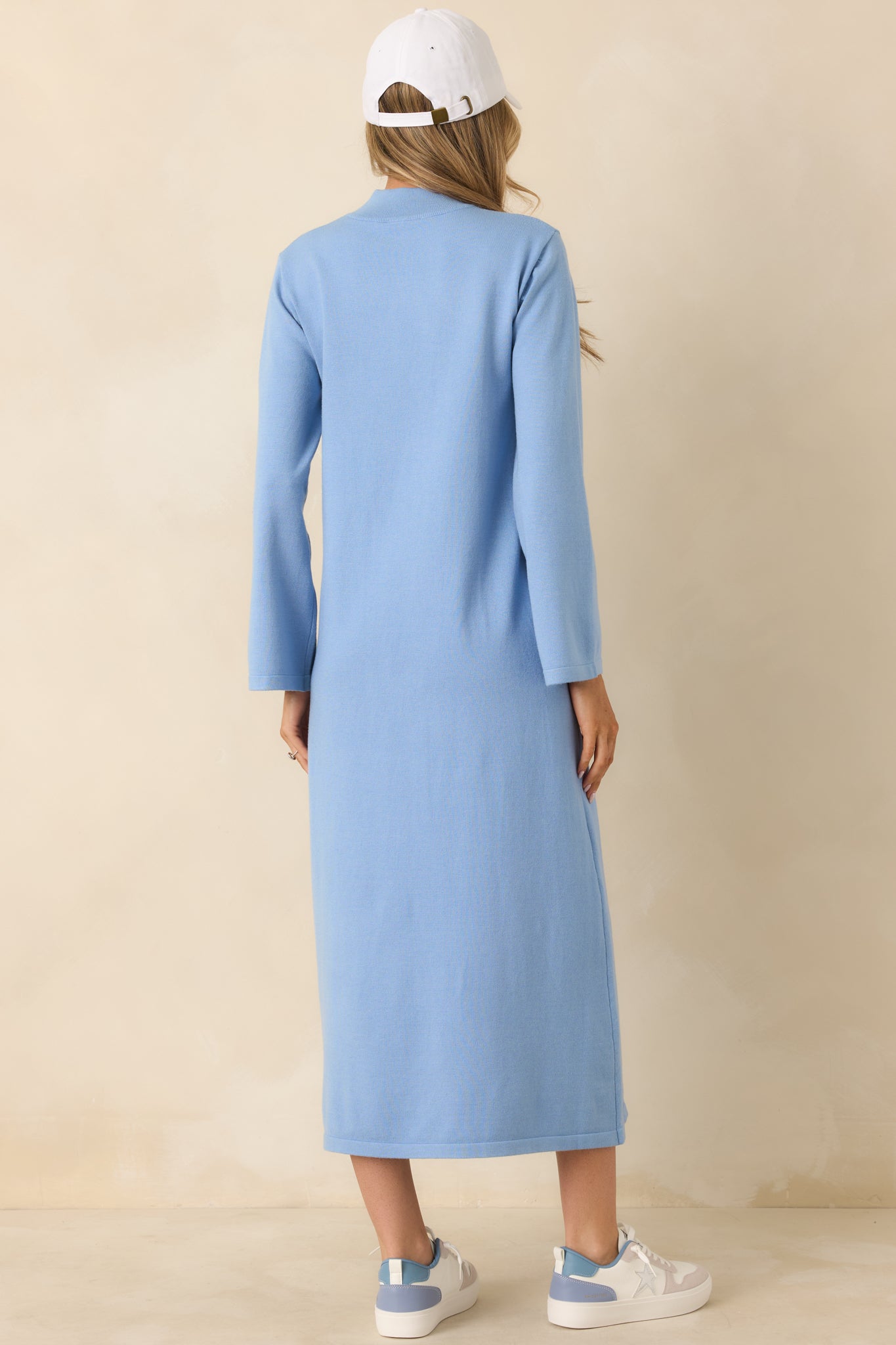 Light blue knit midi dress with a straight silhouette and long sleeves, shown from the rear.