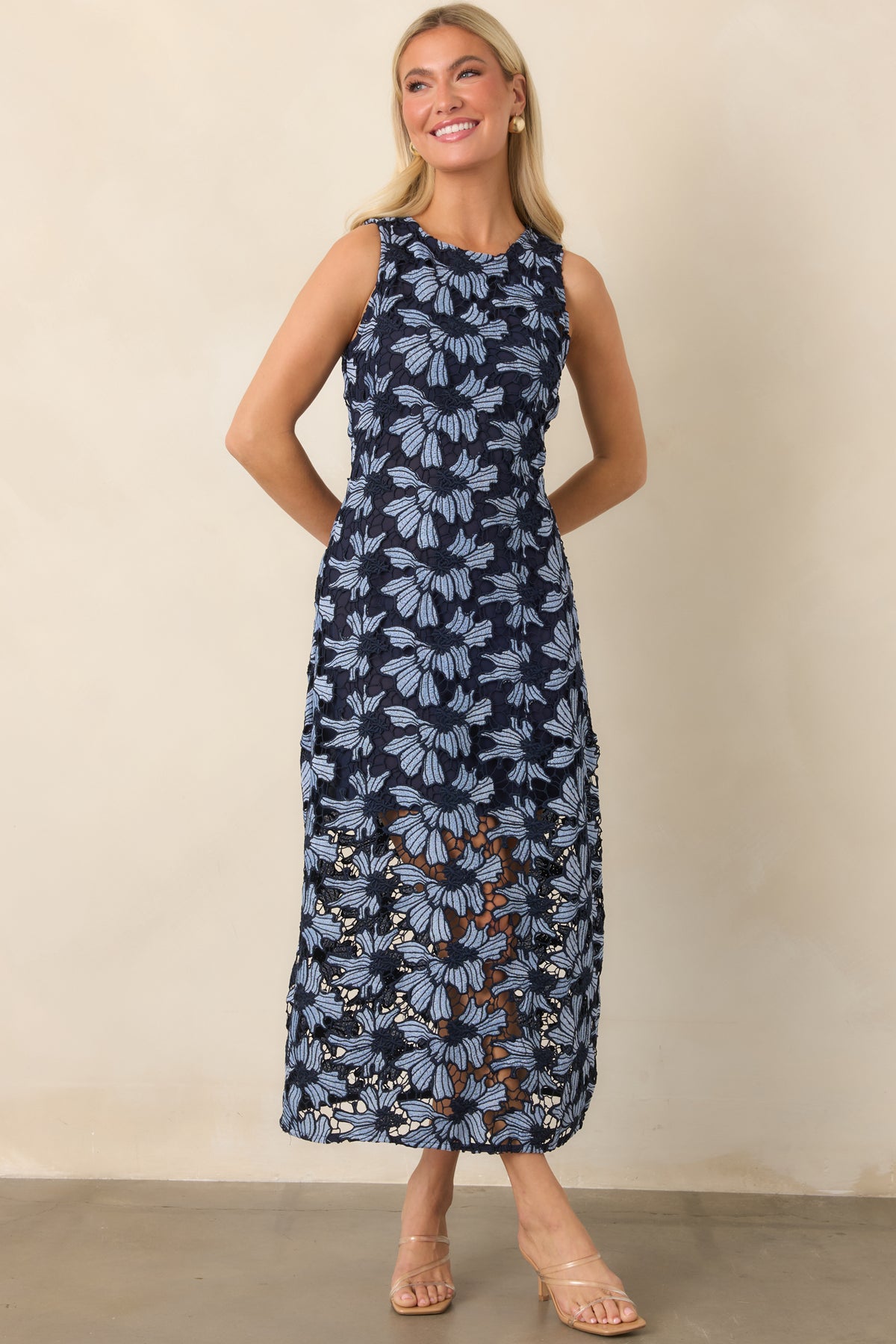 Light blue floral dress featuring dimensional navy-outlined flowers and an airy lace-trimmed skirt.